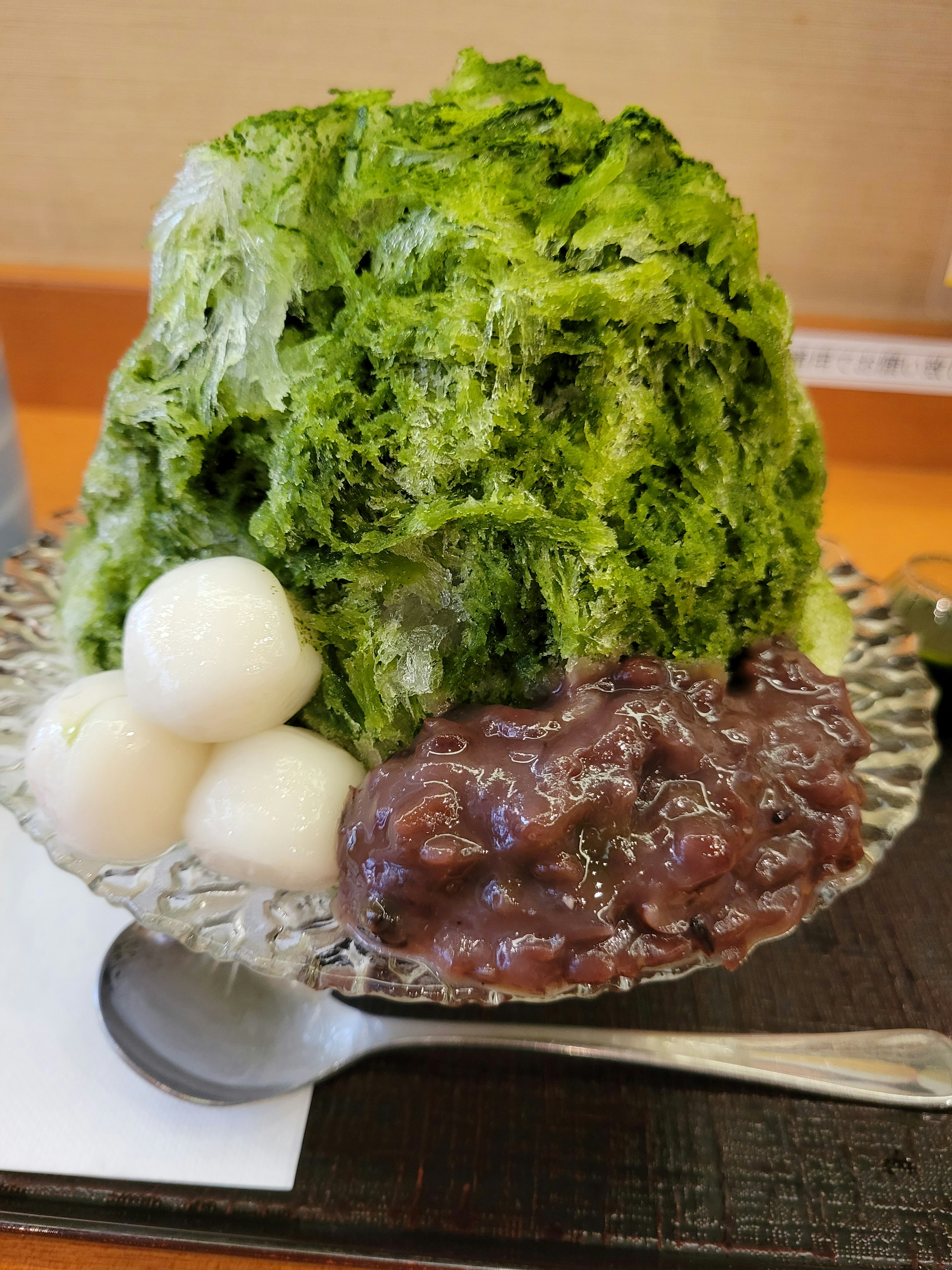 Matcha shaved ice topped with mochi and red bean paste