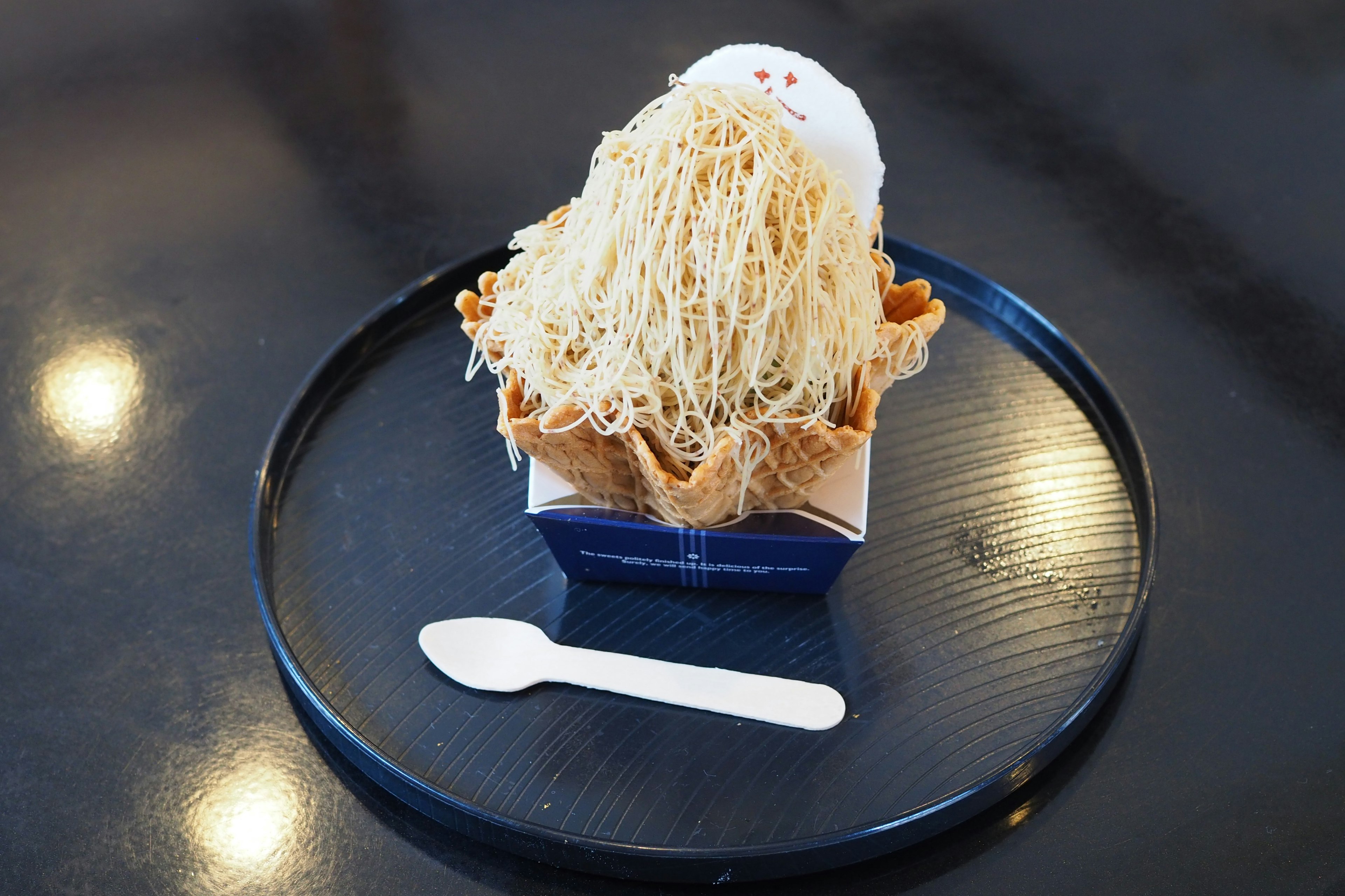 Dessert featuring white ice cream topped with thin noodles