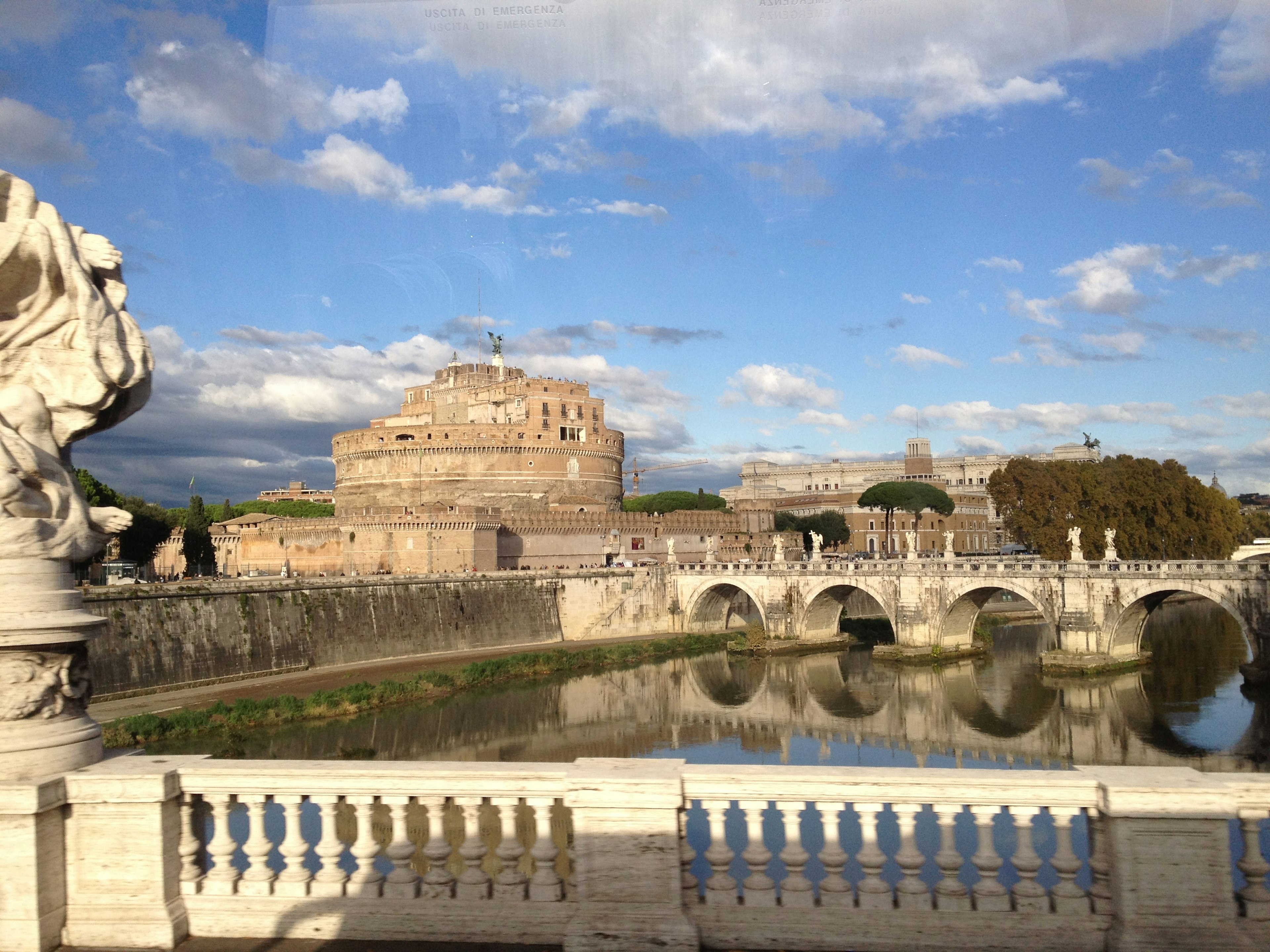 View of Castel Sant'Angelo over the Tiber River with a bridge