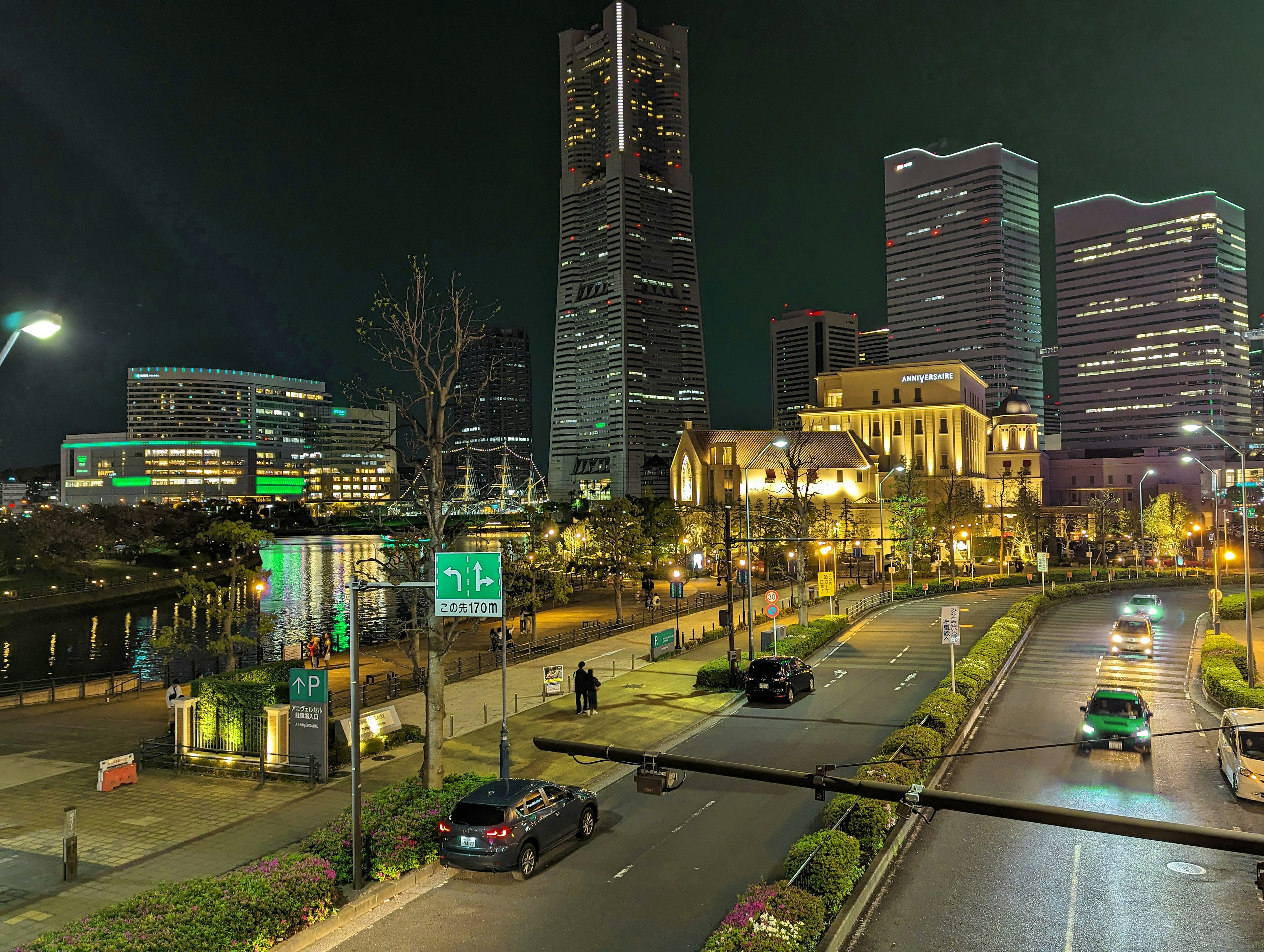 Paisaje urbano nocturno con rascacielos y farolas con vehículos en movimiento