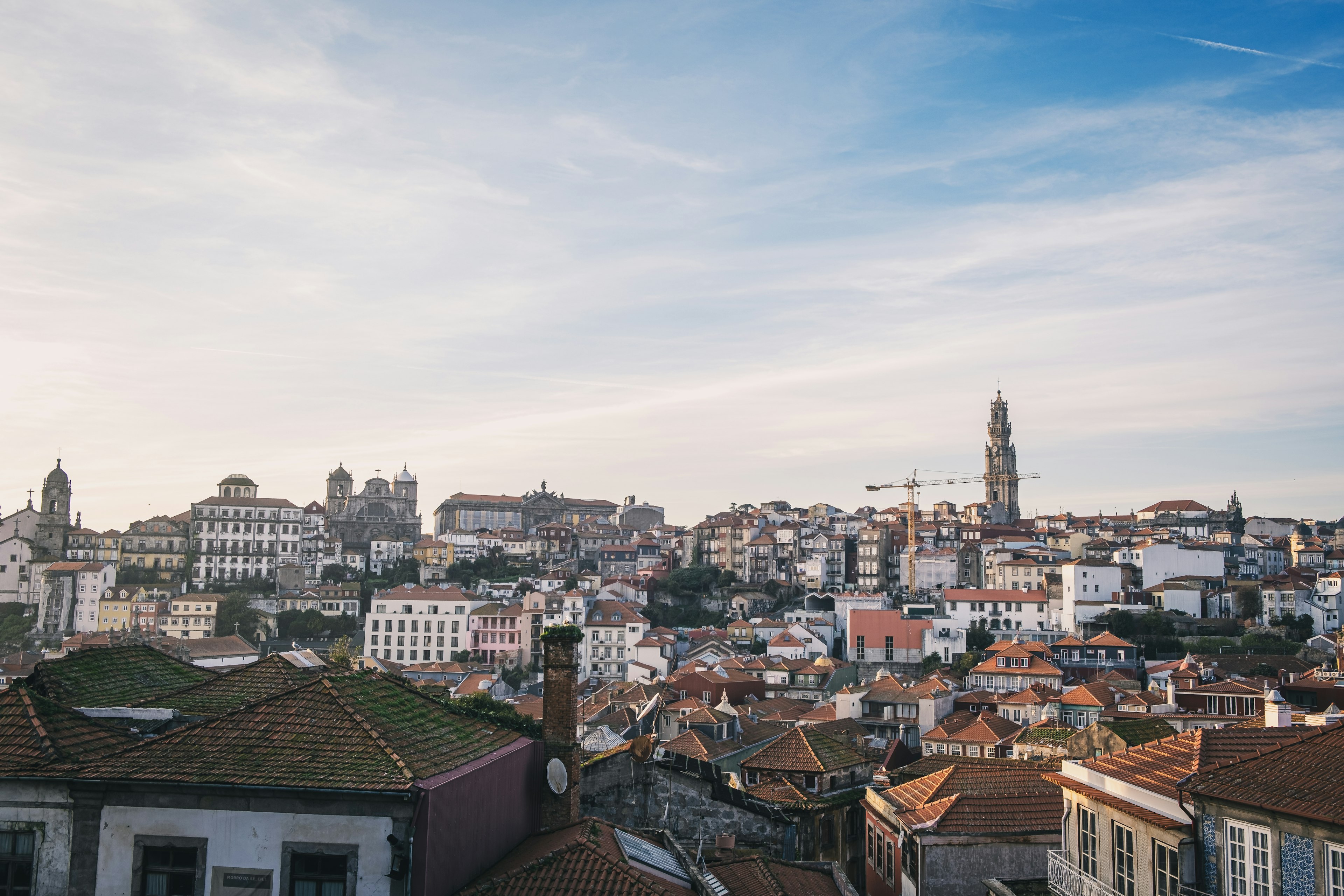 Cityscape of Porto with blue sky rooftops and historic buildings