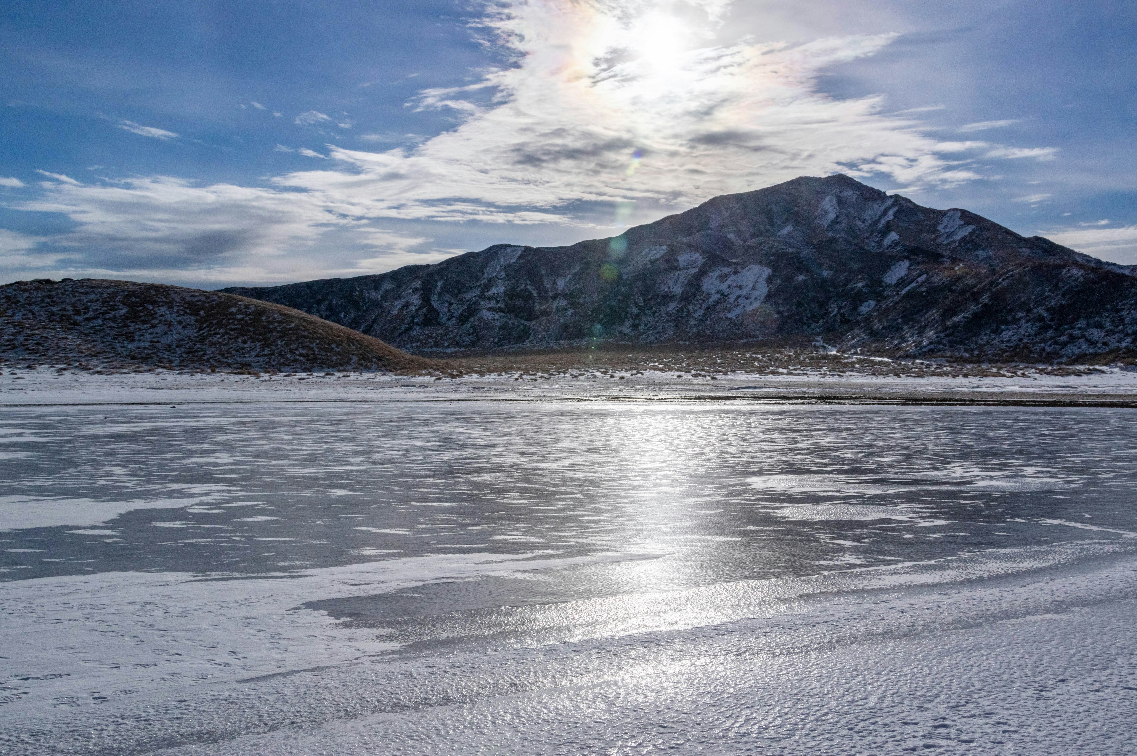 Scenic view of a snow-covered mountain and frozen lake