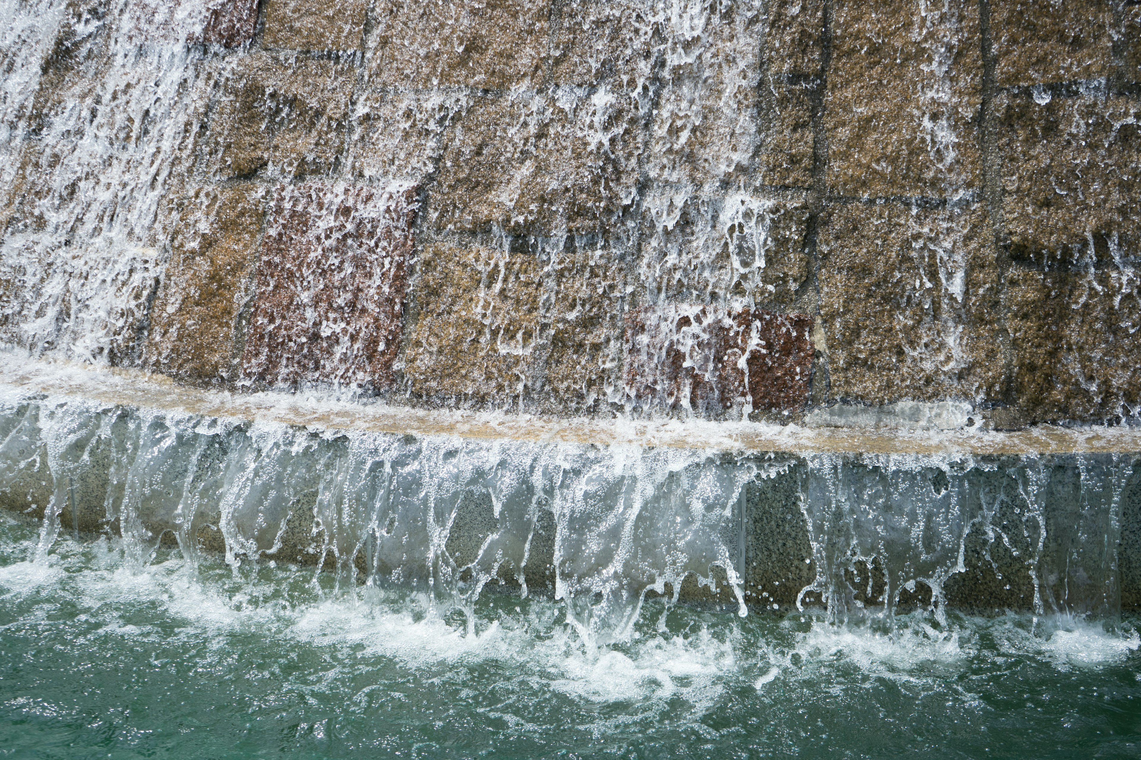 Close-up of a waterfall with flowing water and stone texture