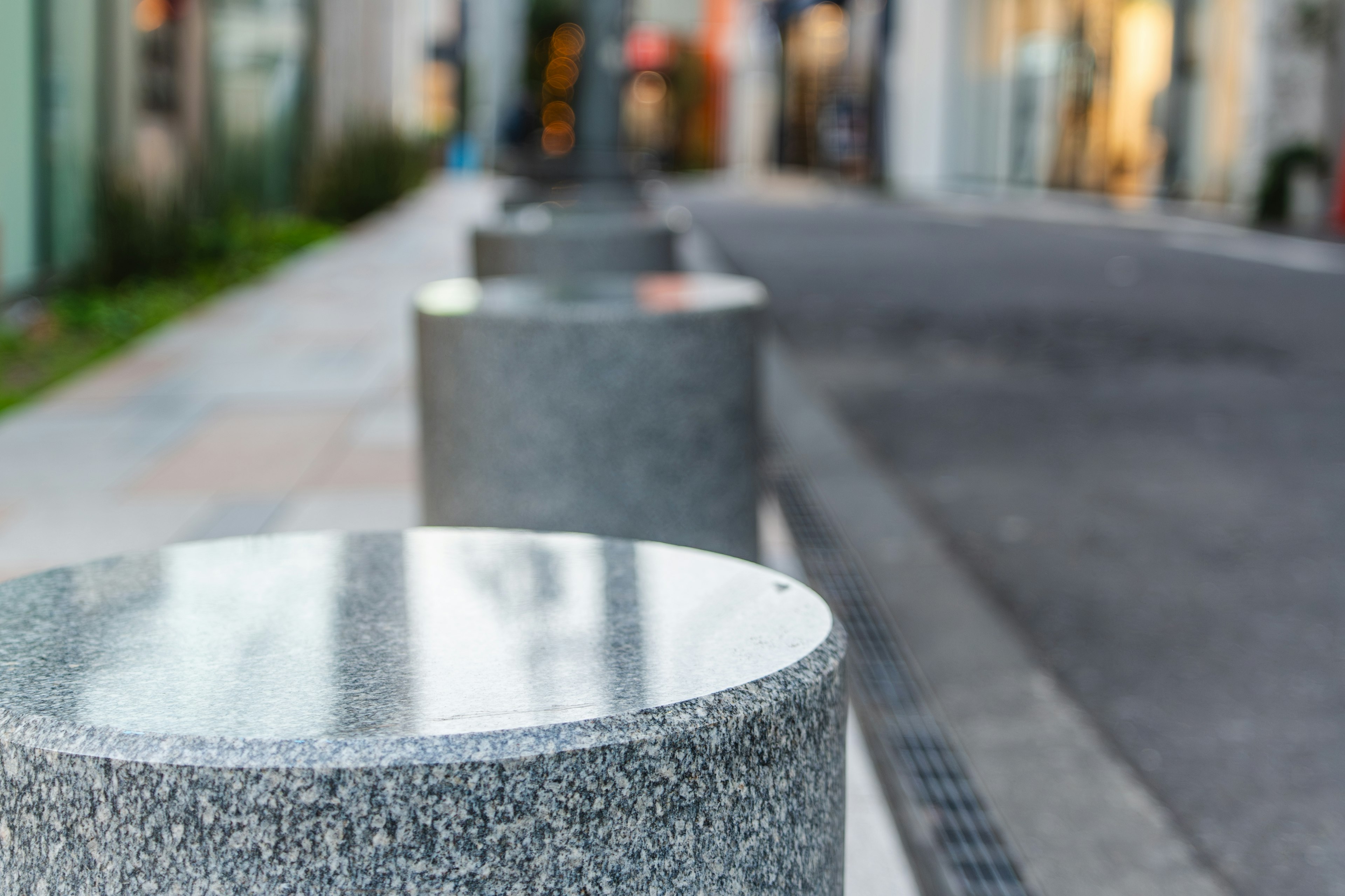 Close-up of round stone bollards in an urban setting