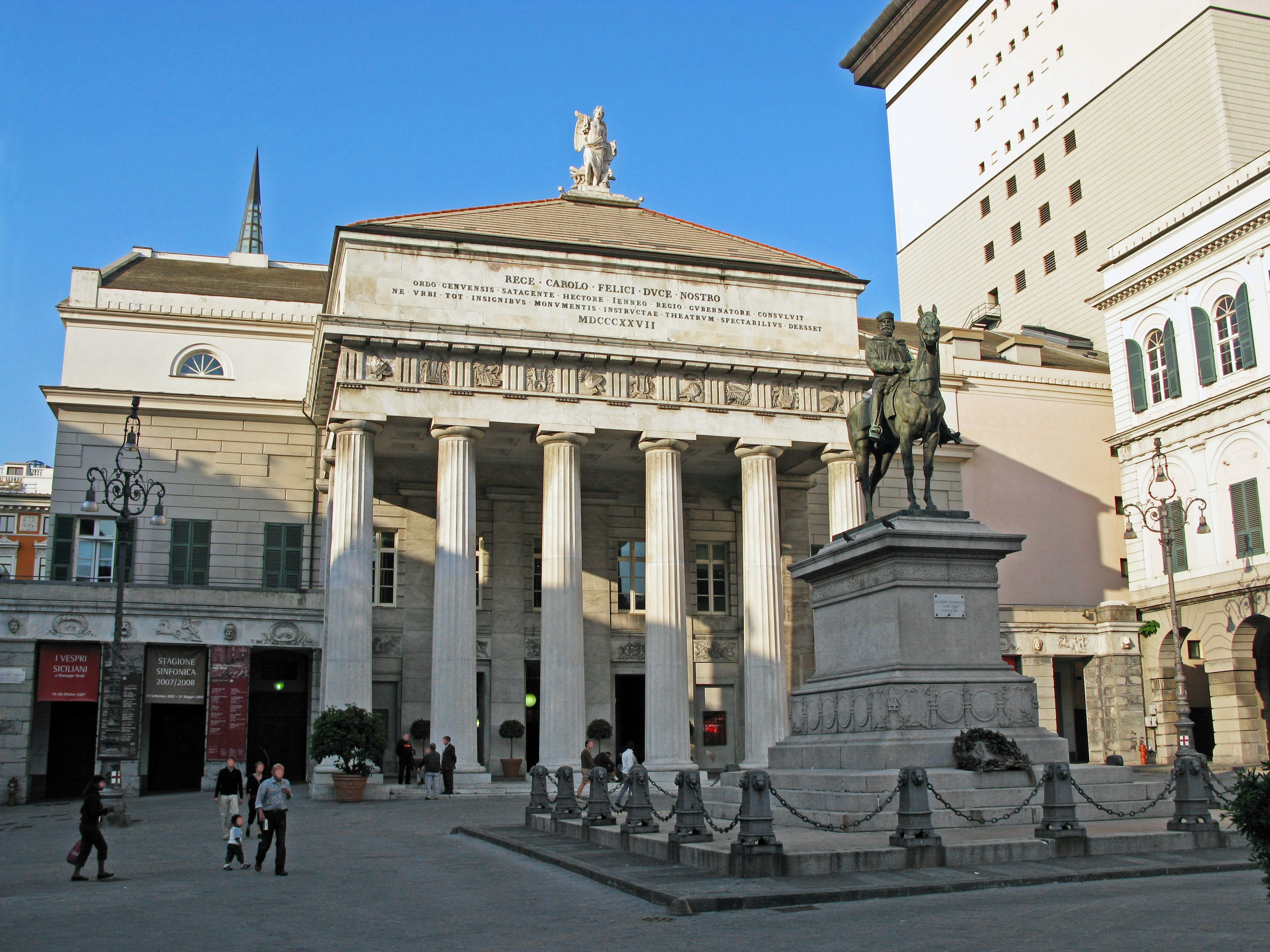 A grand building in a square featuring a statue of Giordano Bruno