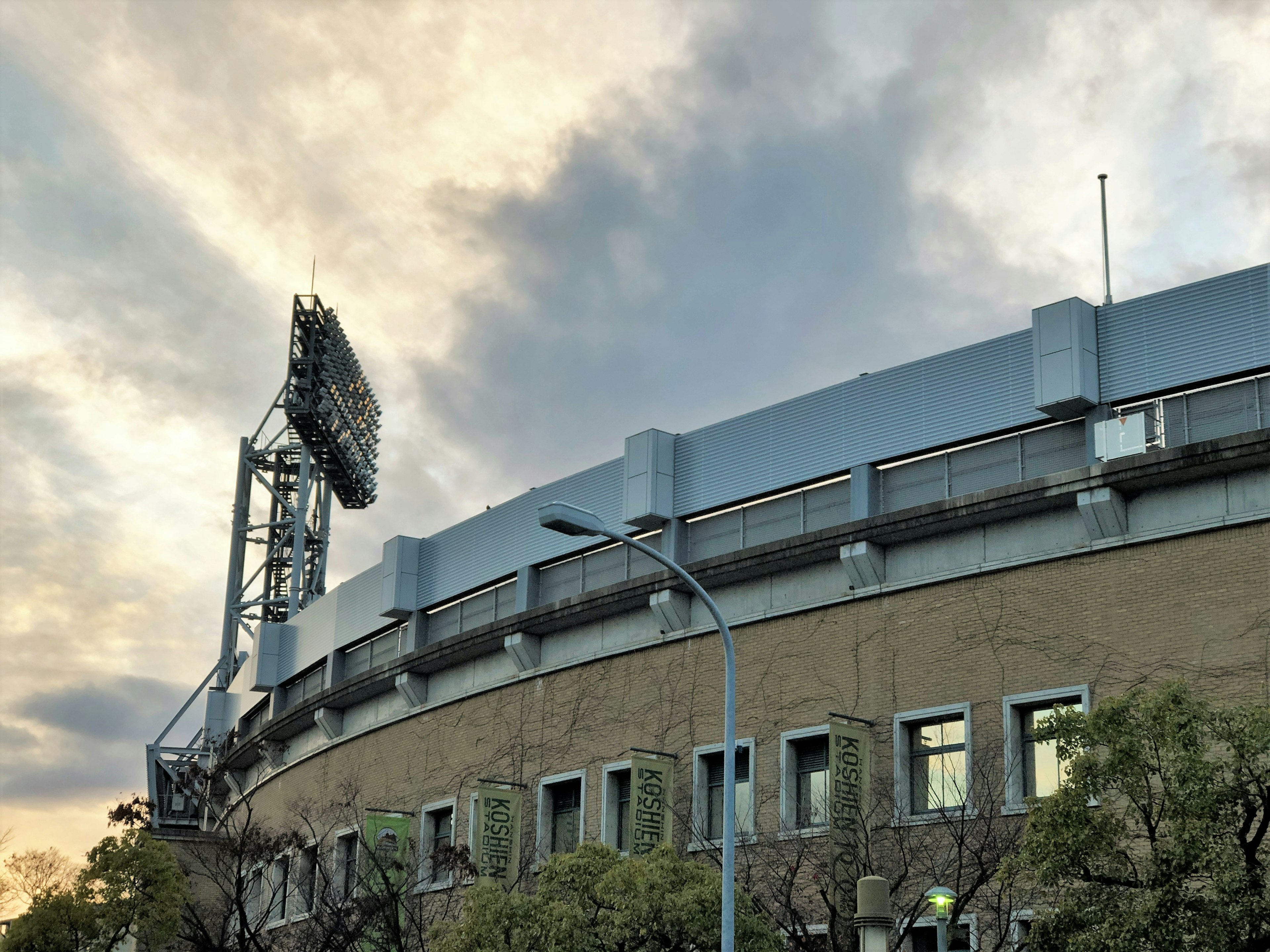 Stadium exterior with a cloudy sunset sky