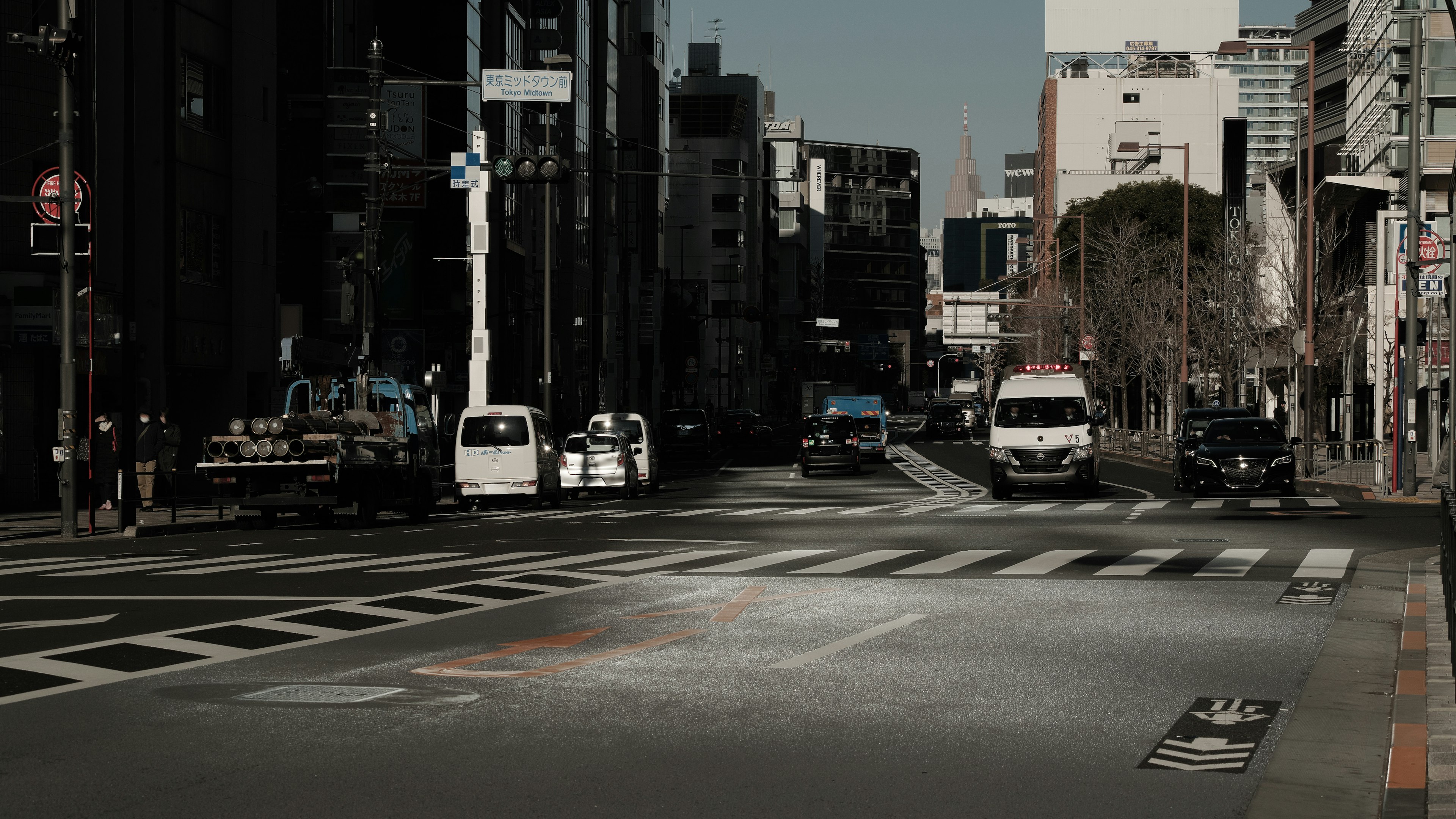 Quiet city intersection with vehicles and buildings