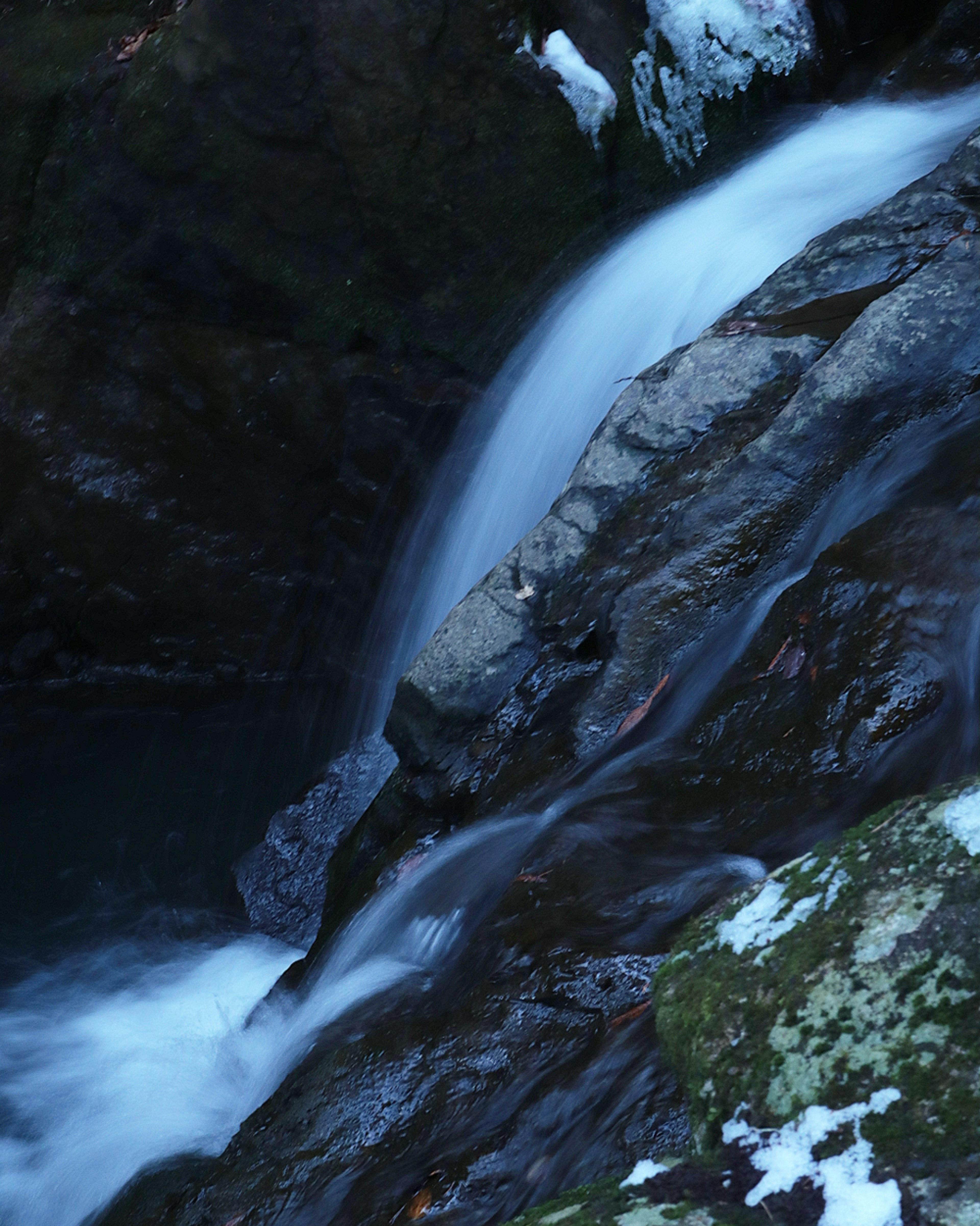 Una bellissima cascata d'acqua che scorre su rocce in un'atmosfera serena