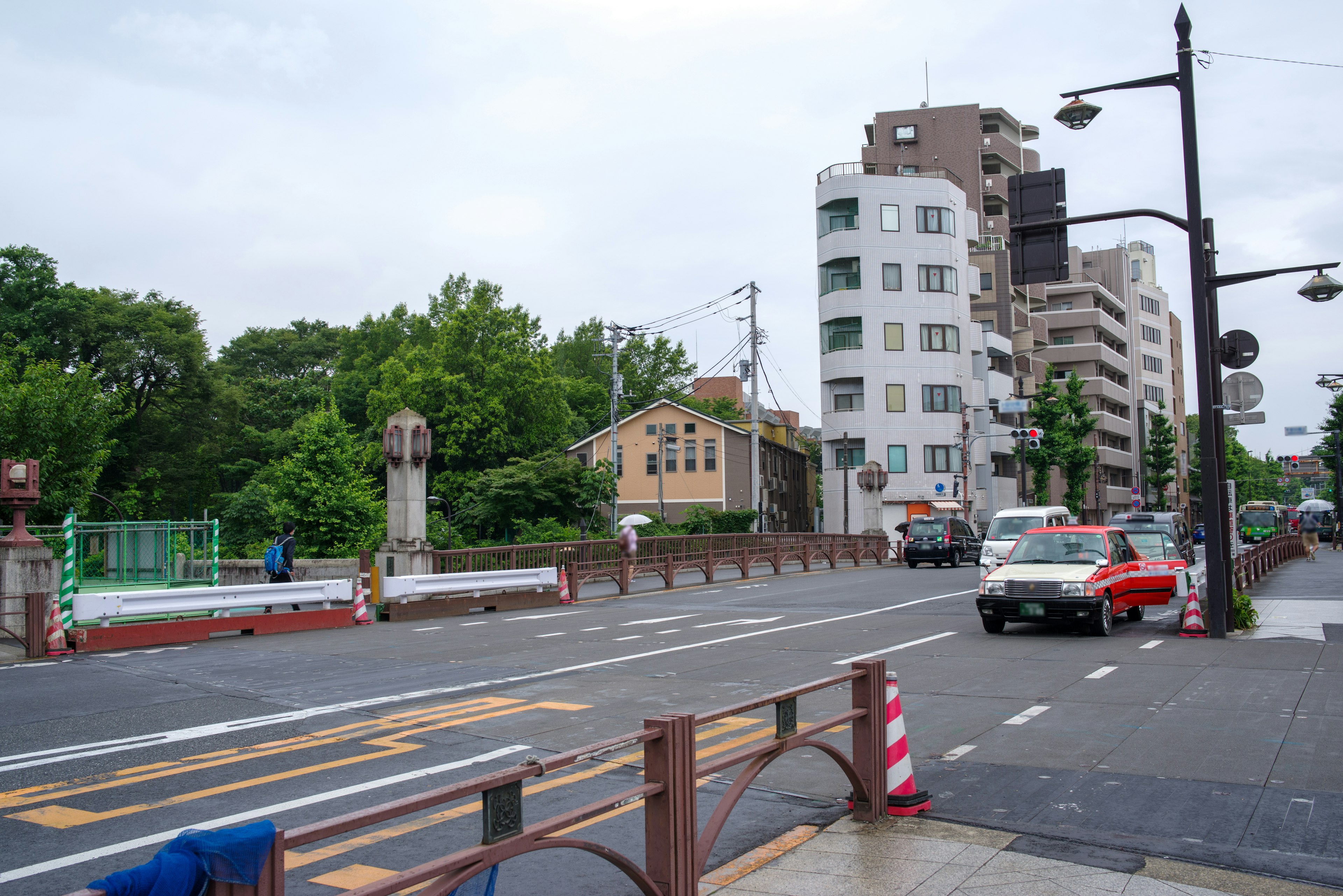 Street view featuring greenery and modern buildings