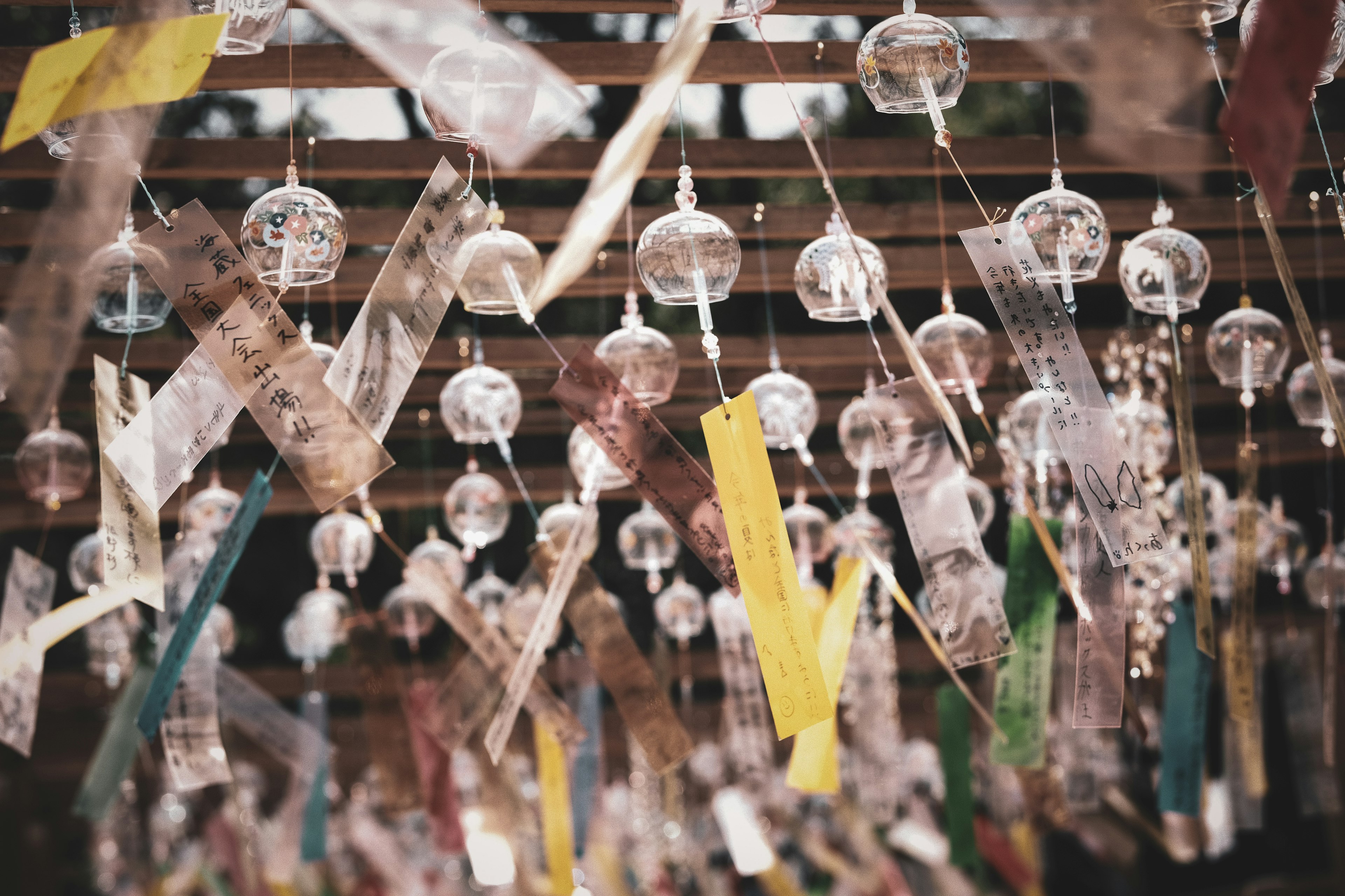 Outdoor scene with hanging wind chimes colorful ribbons fluttering in the wind