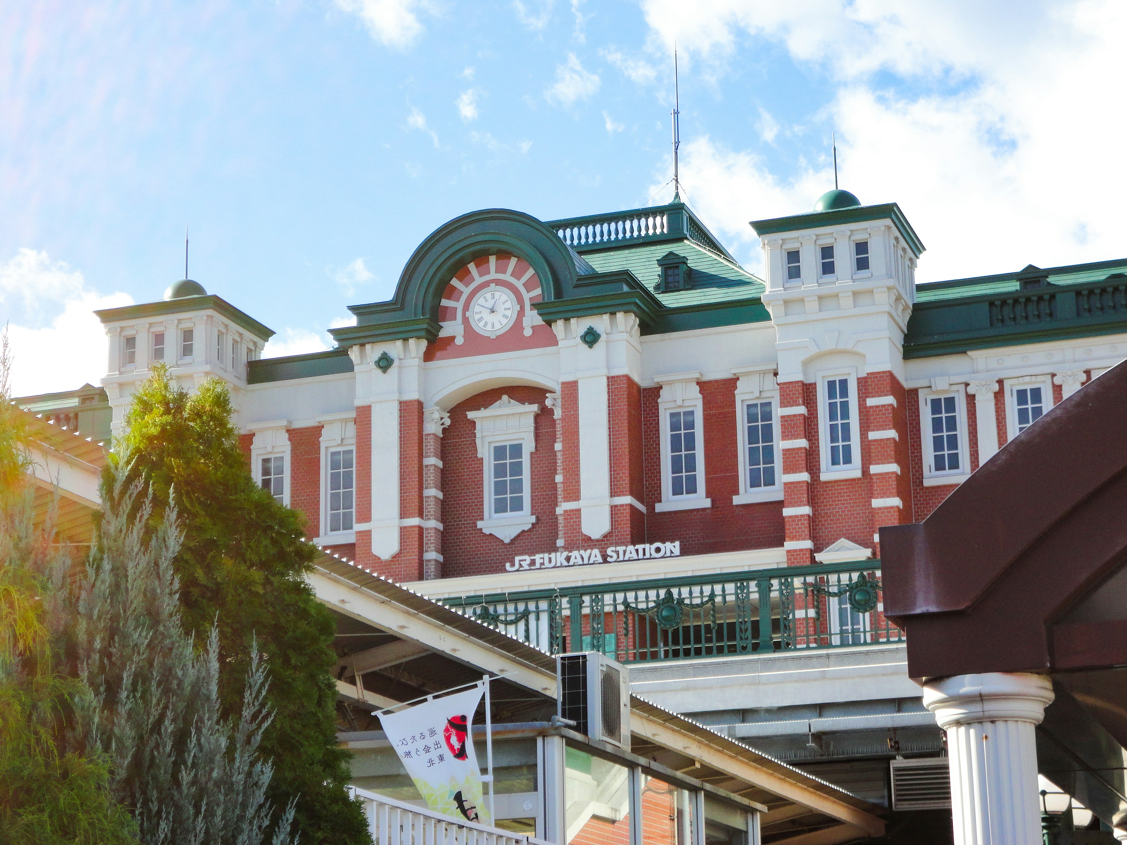 Historical building with red and white facade featuring a clock and towers