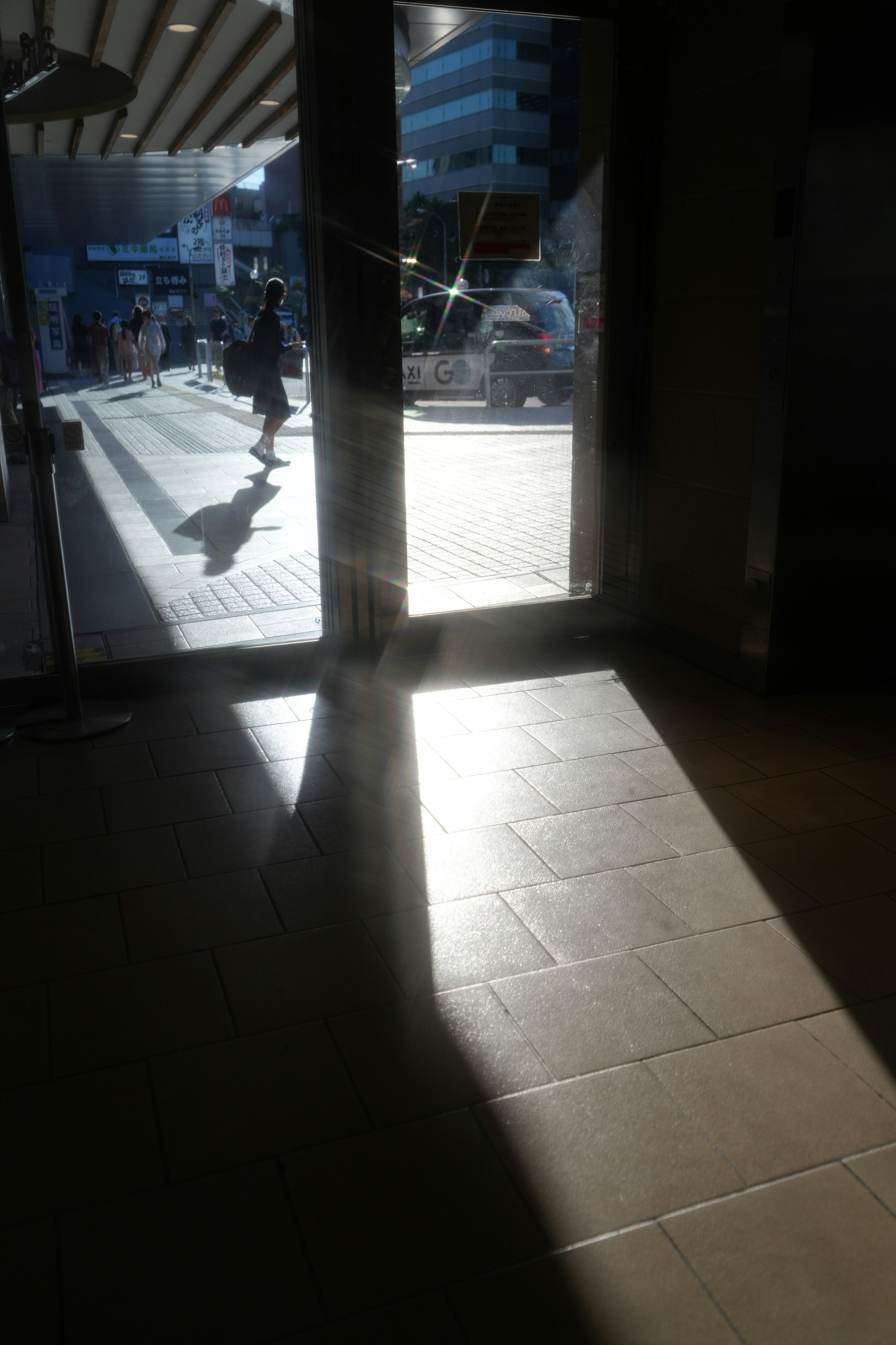 View from an indoor entrance with sunlight streaming through the door