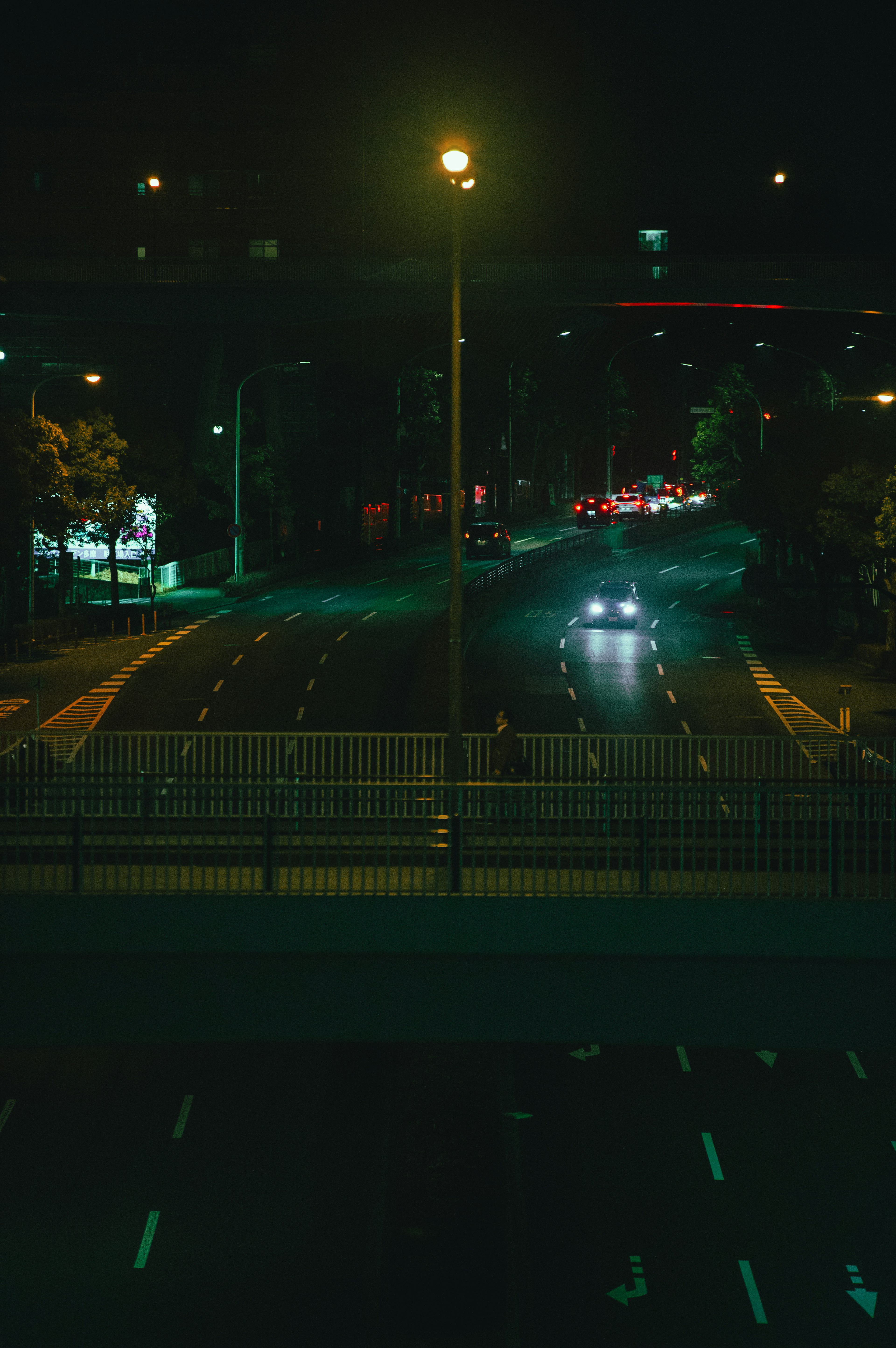 View of a car driving through a city intersection at night