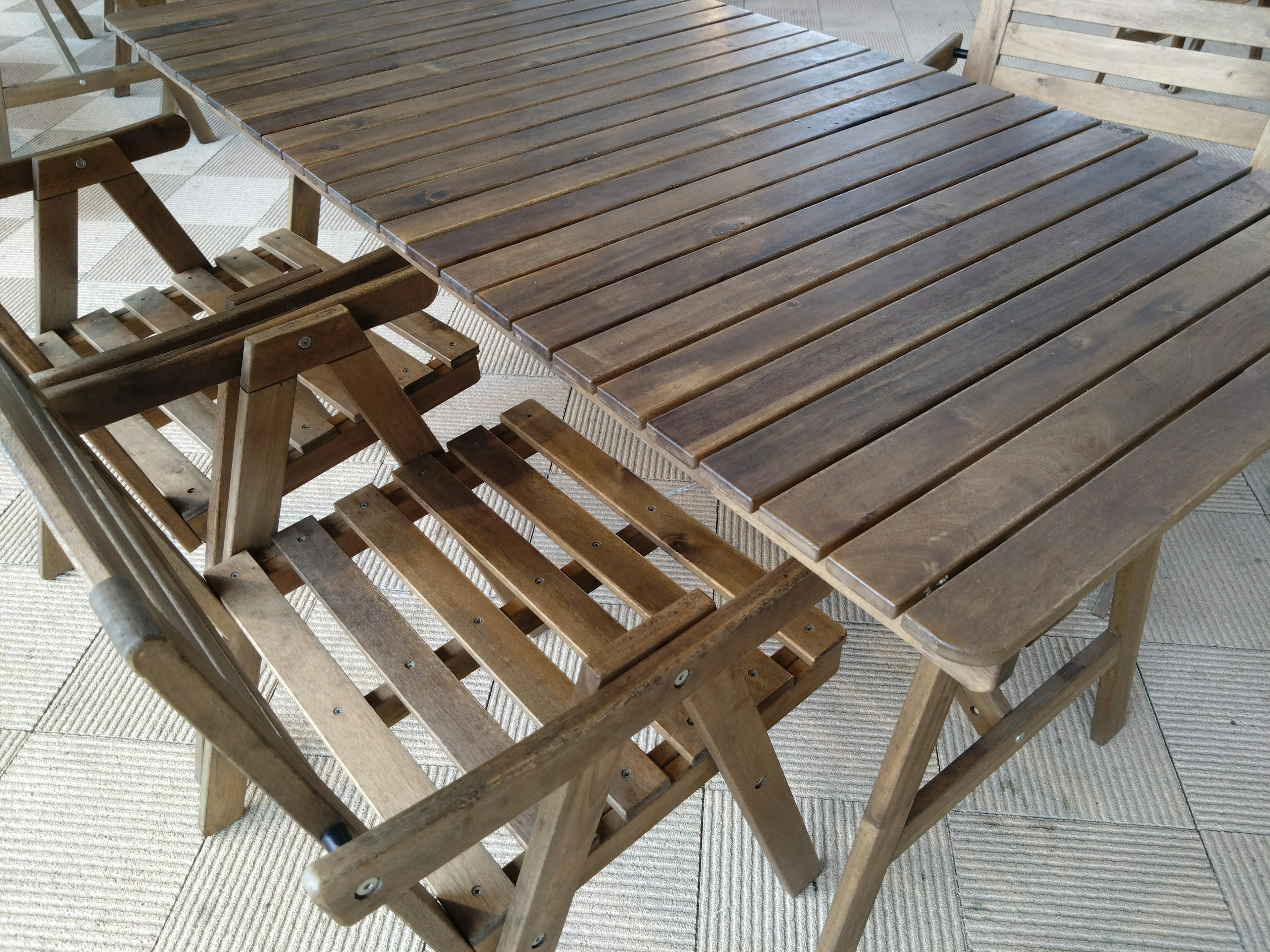 Juego de mesa y sillas de madera en un espacio exterior