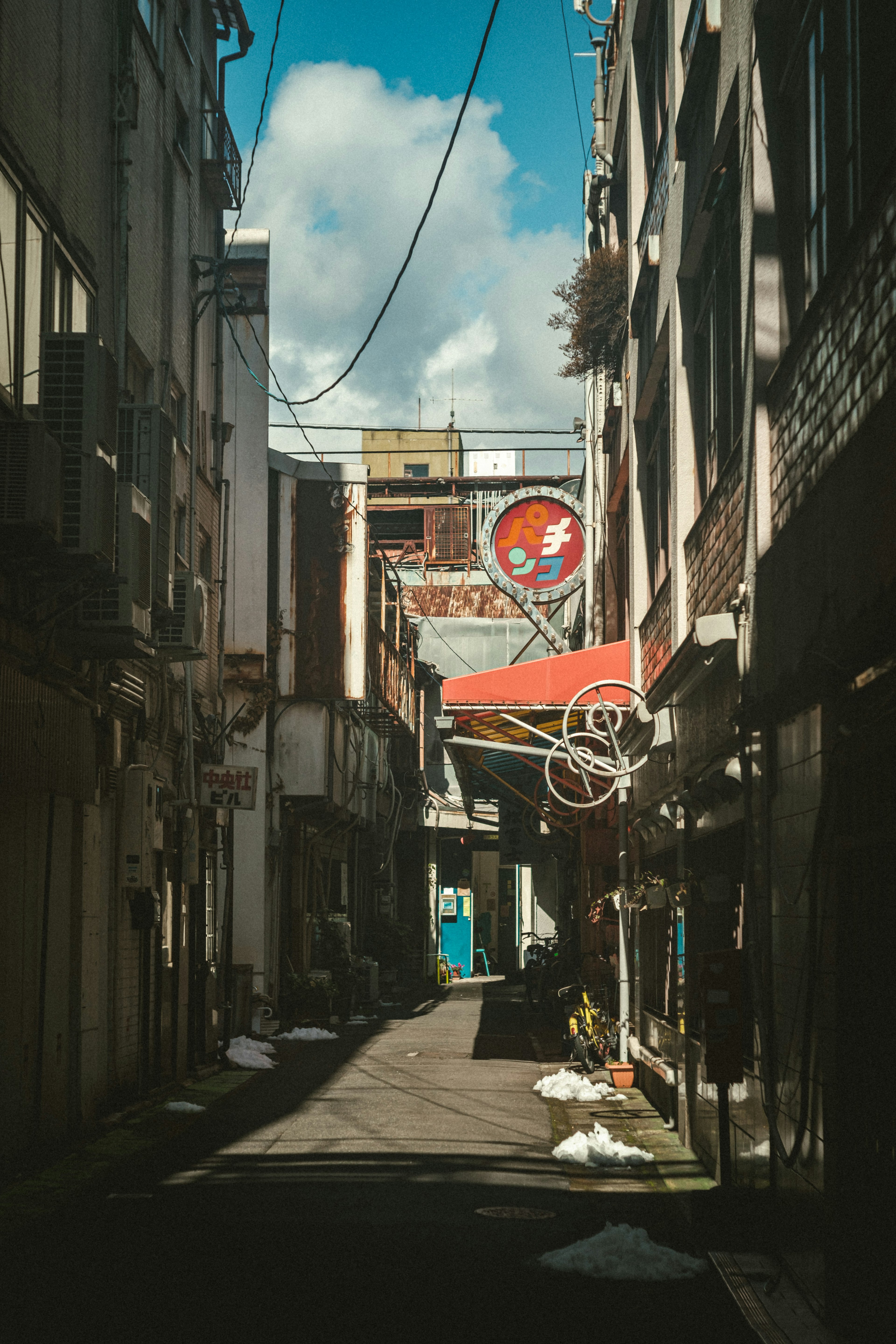 Callejón estrecho con tiendas y cielo azul