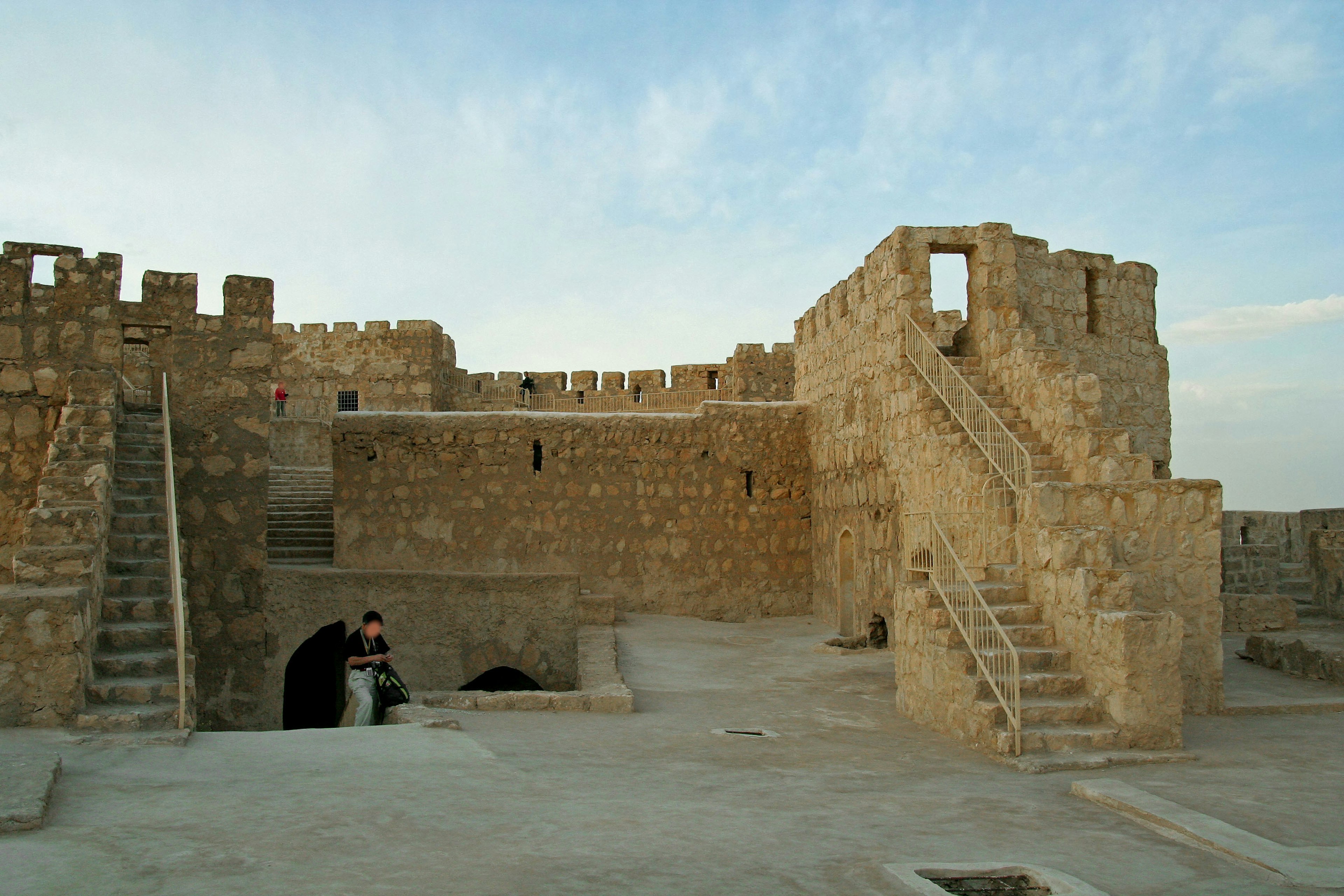 Rovine di un'antica fortezza con muri di pietra e scale