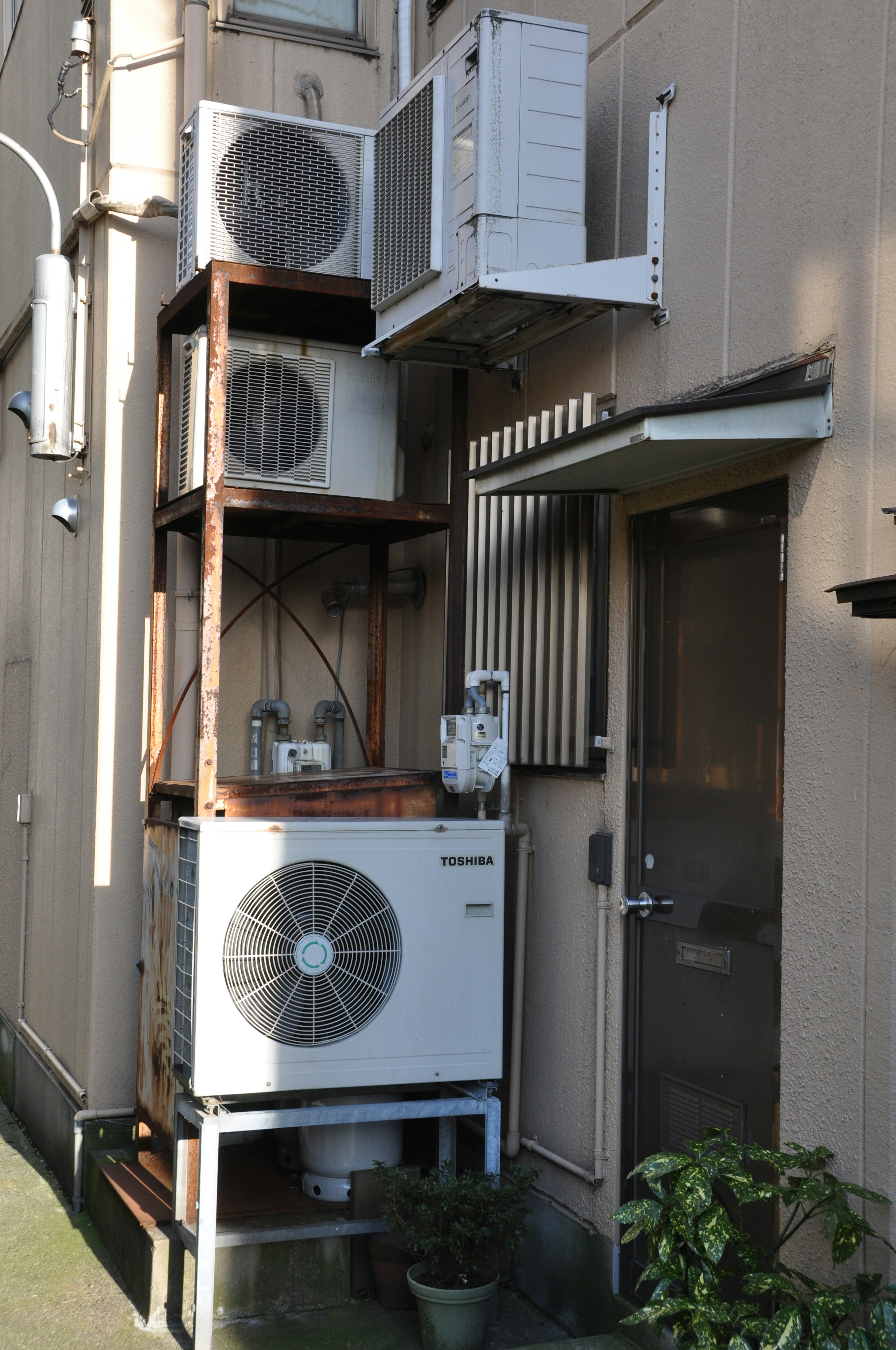 Exterior view of multiple air conditioning units mounted on a wooden structure