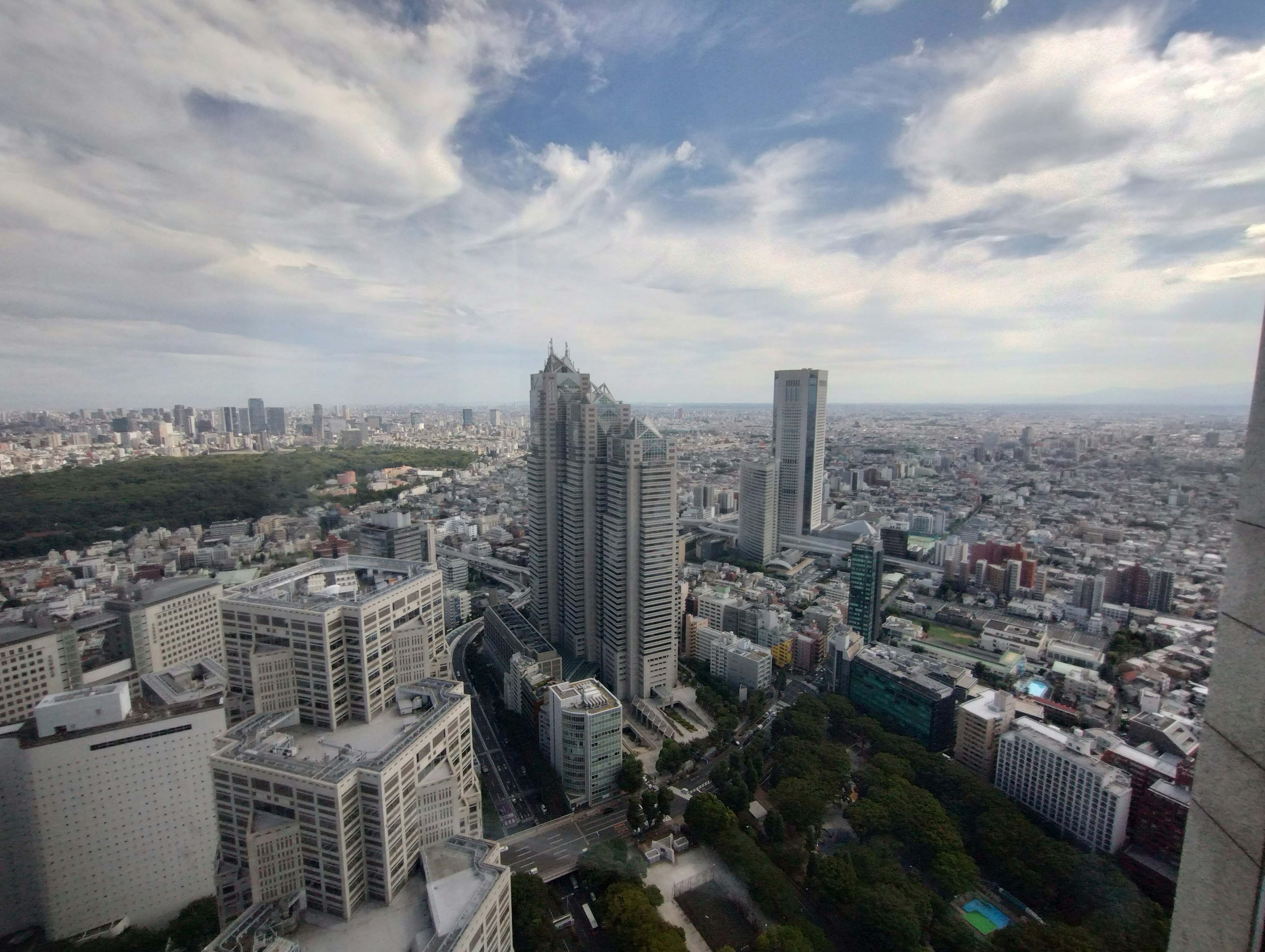 Panoramic view of city skyline with tall buildings and blue sky