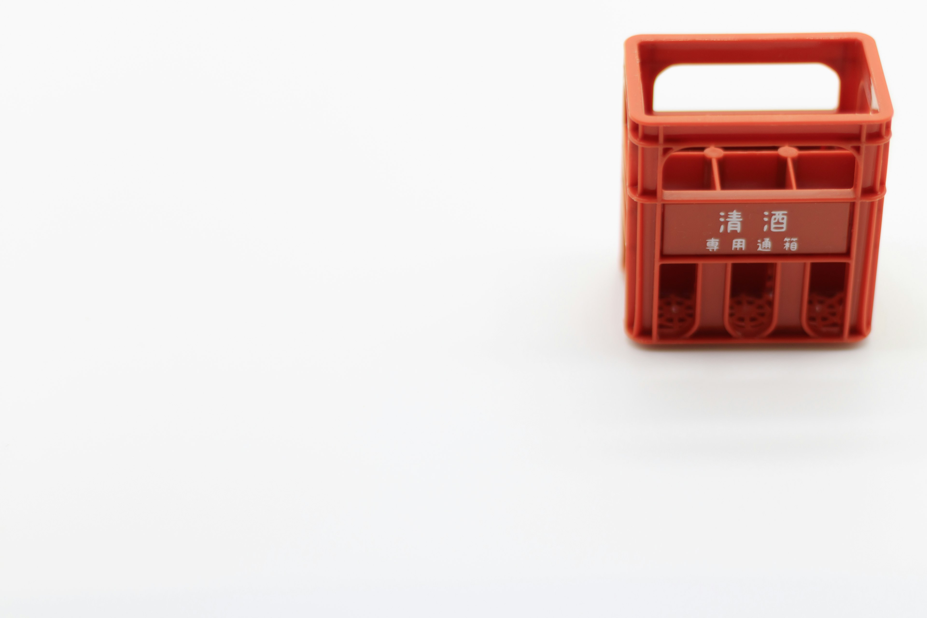 Red plastic crate on a white background