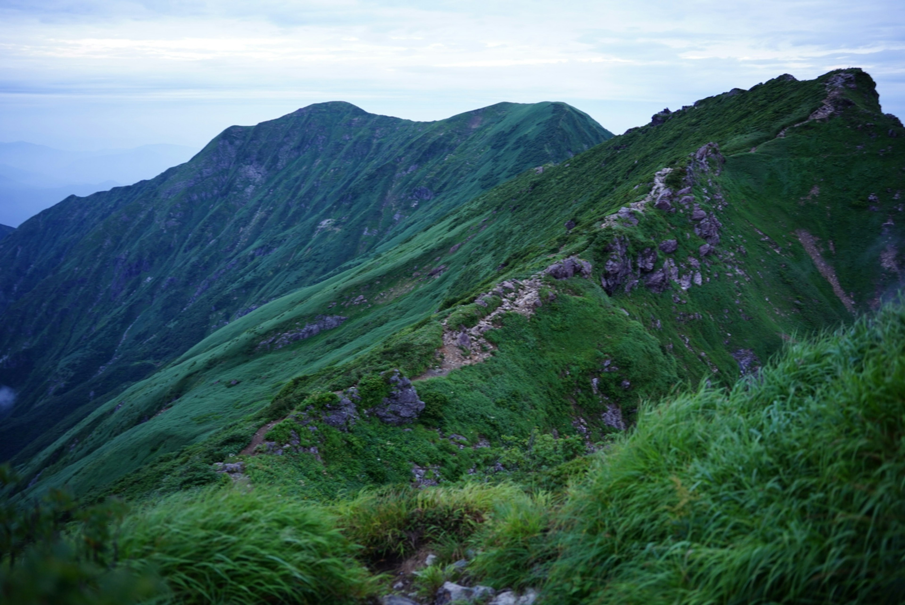 Lush green mountainous landscape with rolling hills