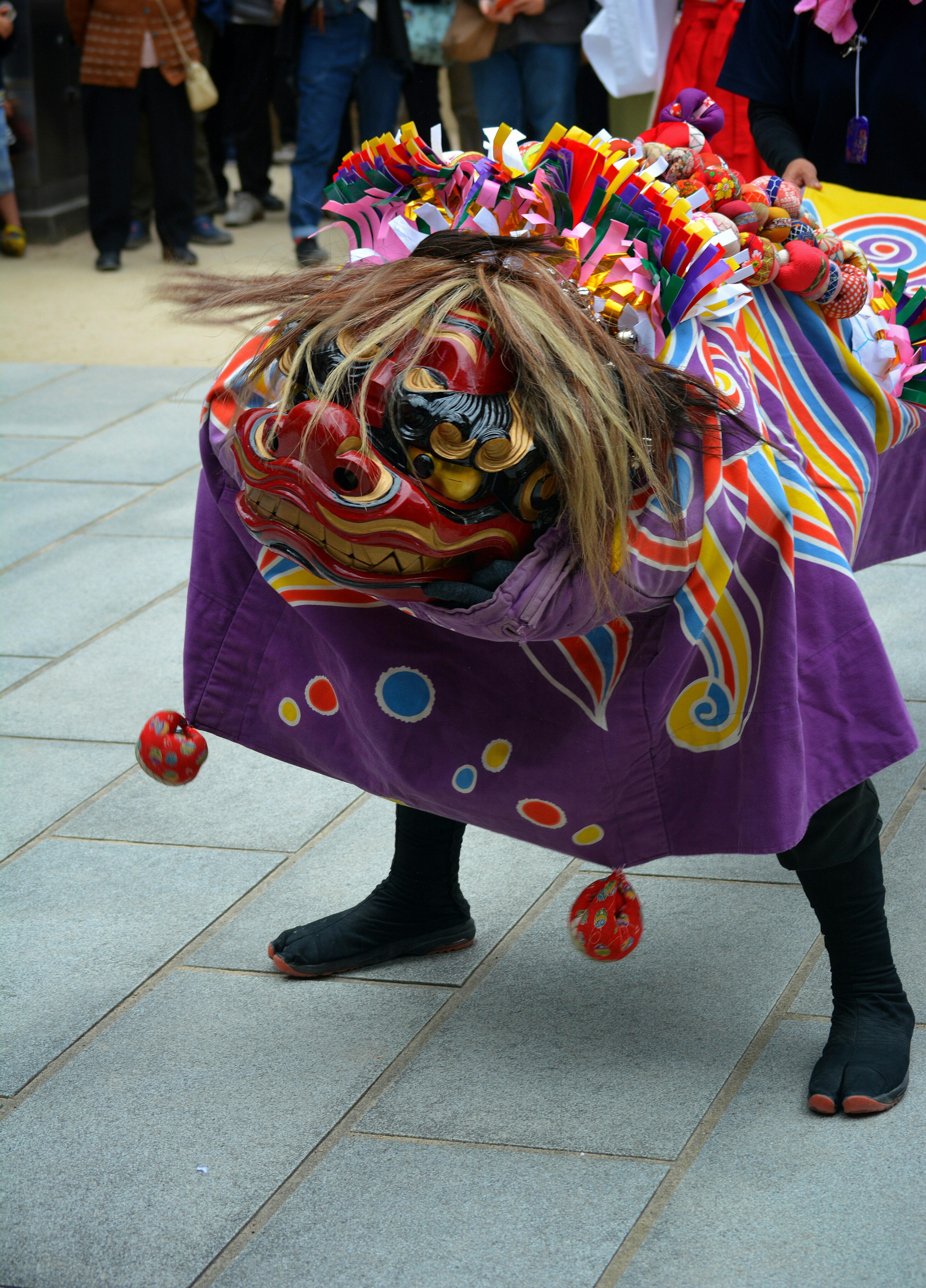 Person performing lion dance in colorful costume