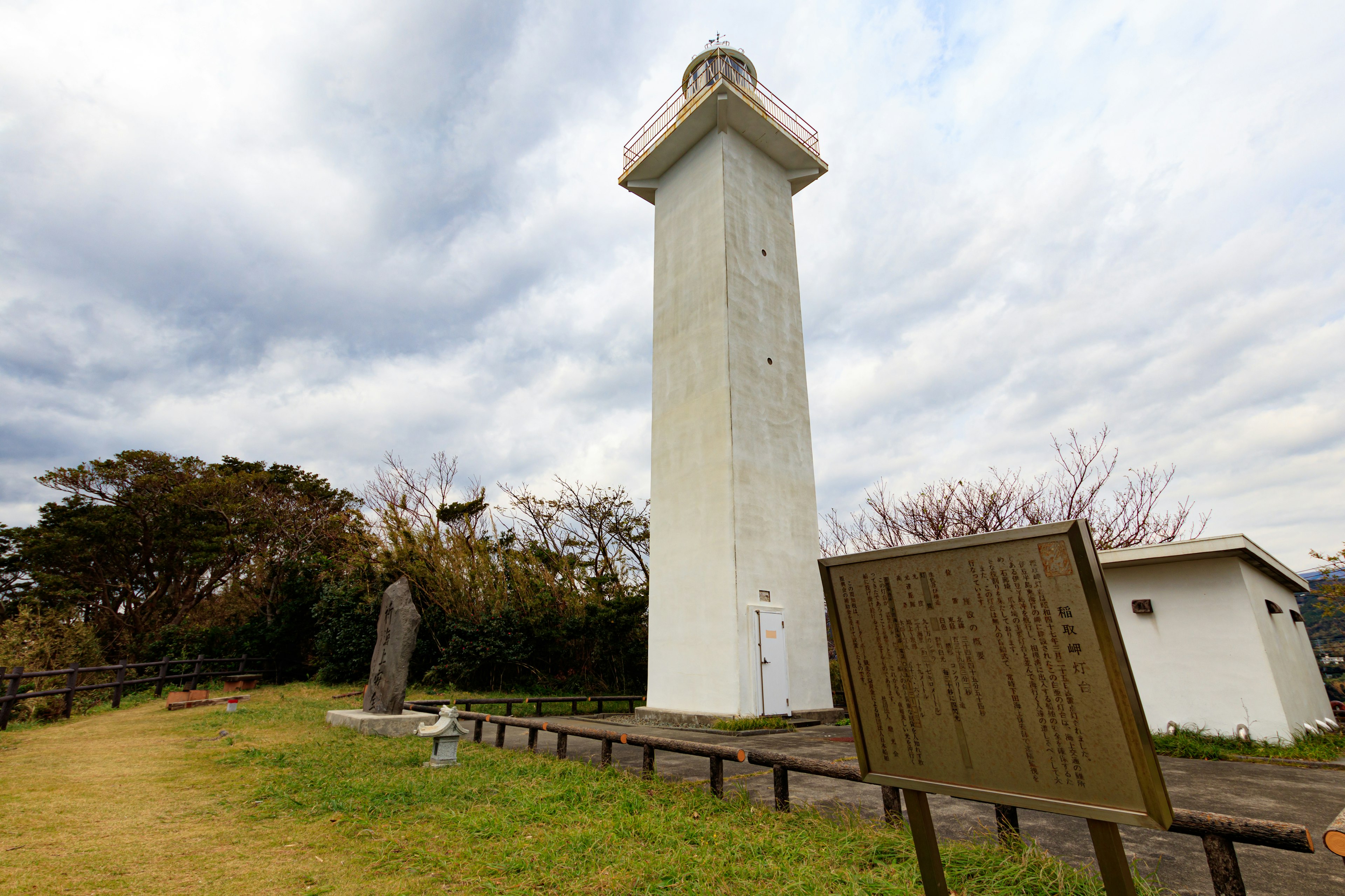 White lighthouse with surrounding natural scenery