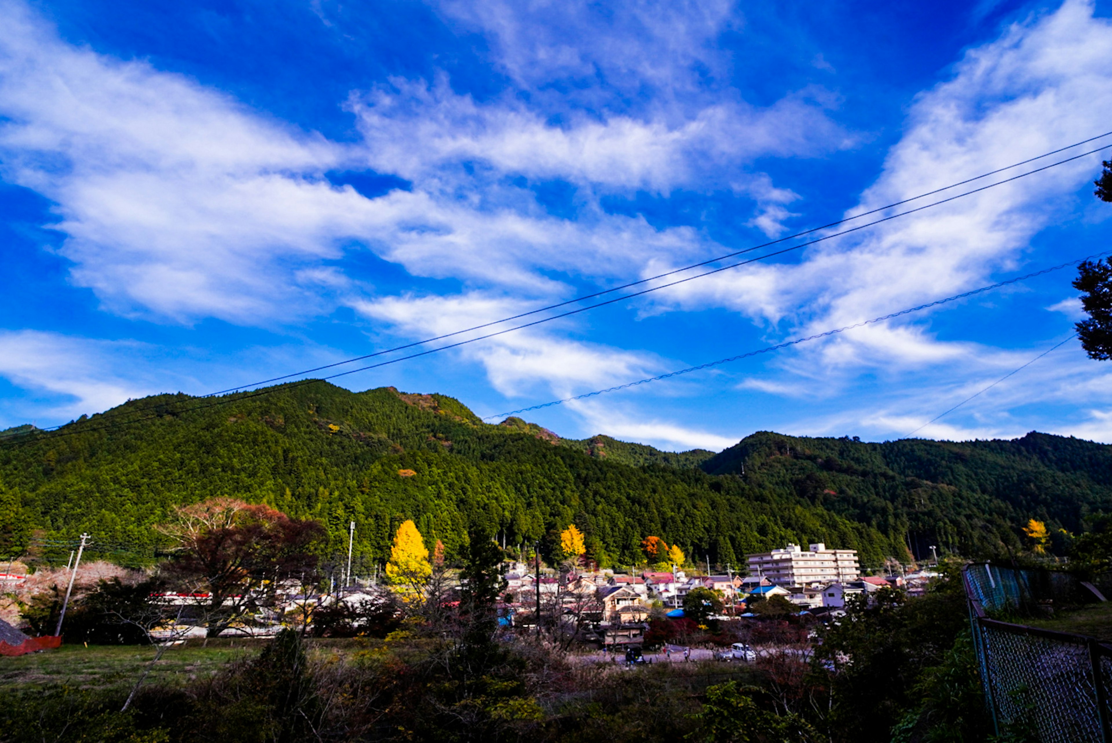 Paesaggio di un villaggio di montagna sotto un cielo blu con nuvole