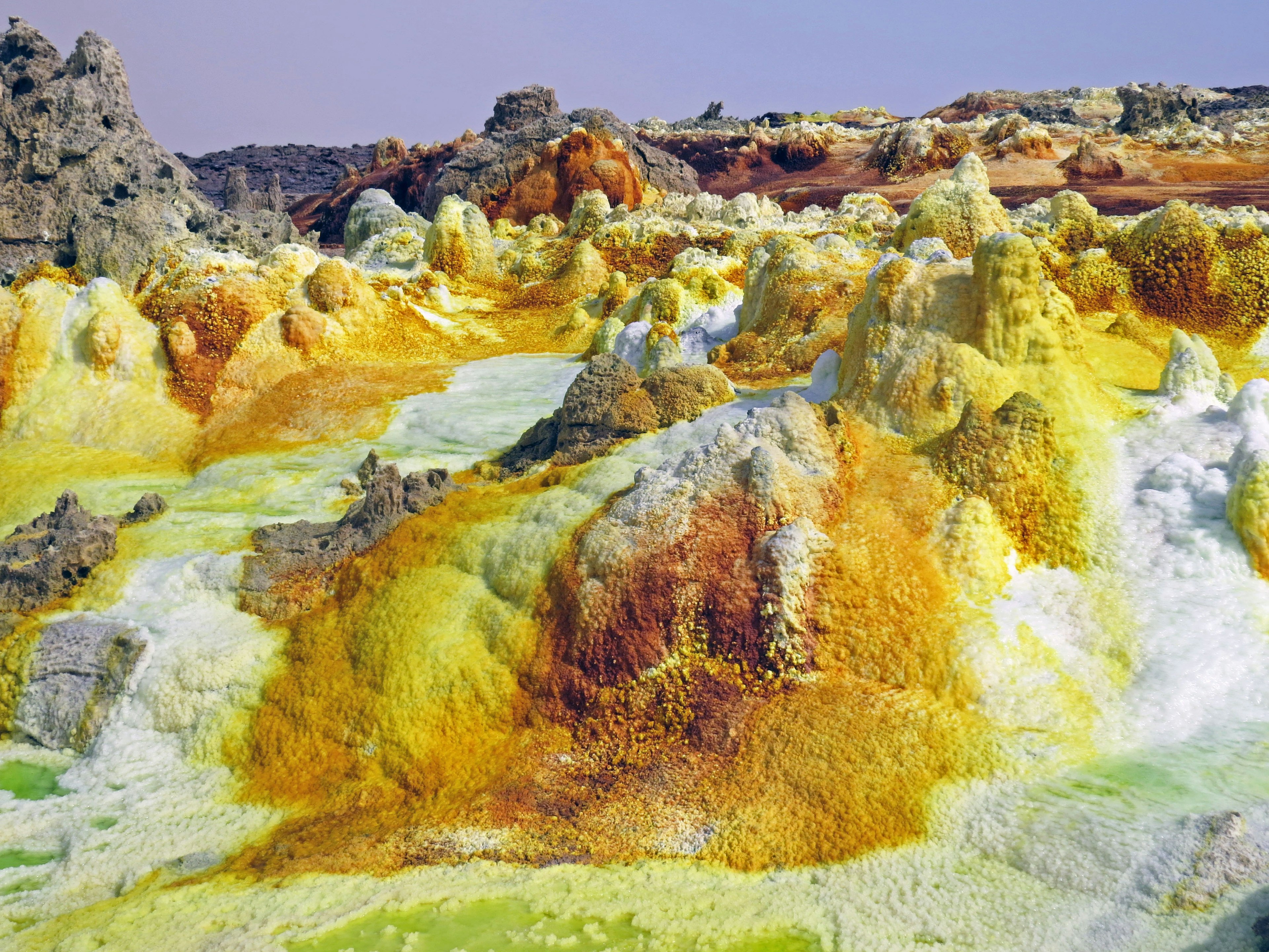 Colorful sulfur landscape with vibrant yellow and green hues