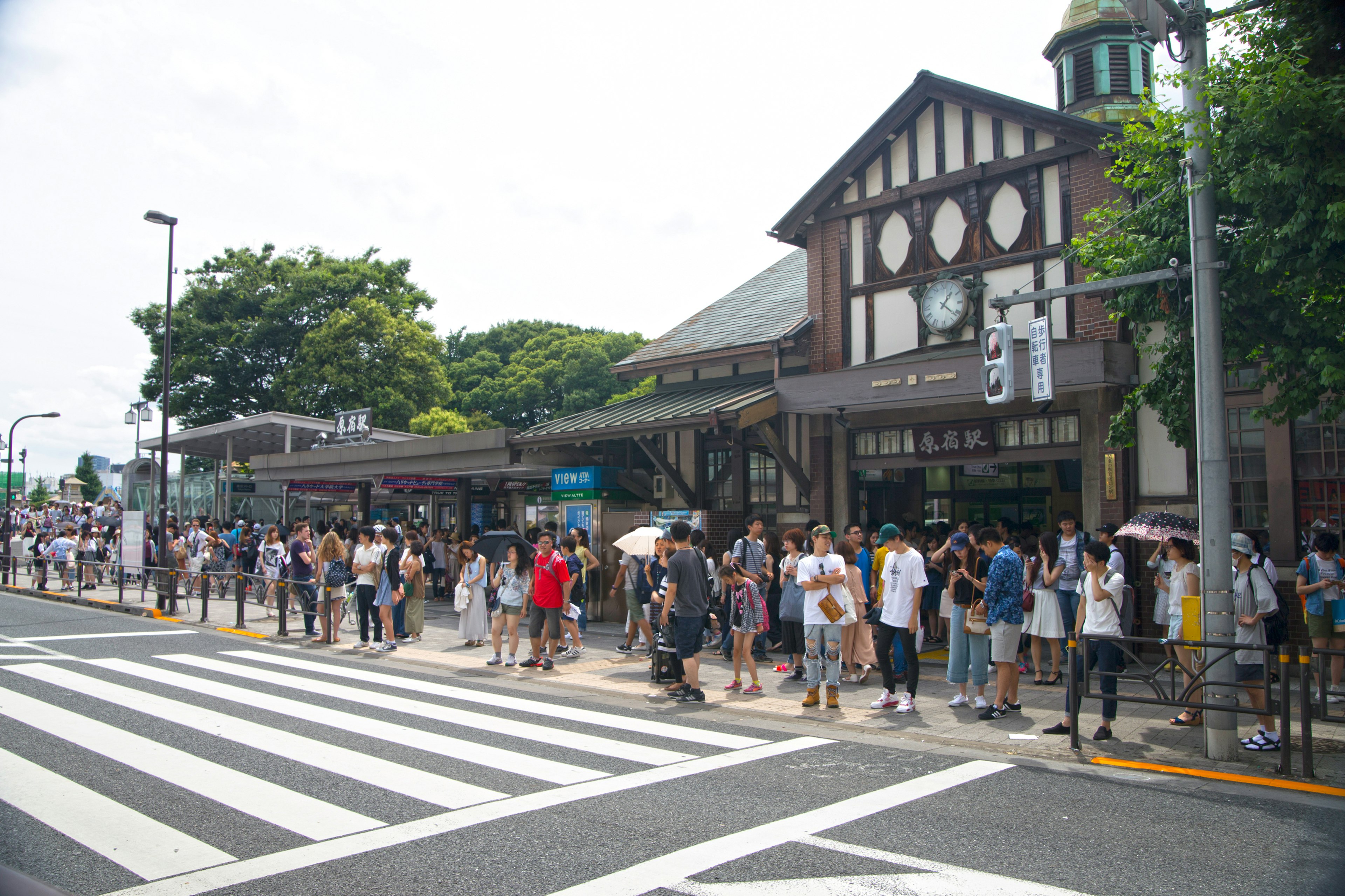 Line of people waiting at Shibuya Station with distinct architecture