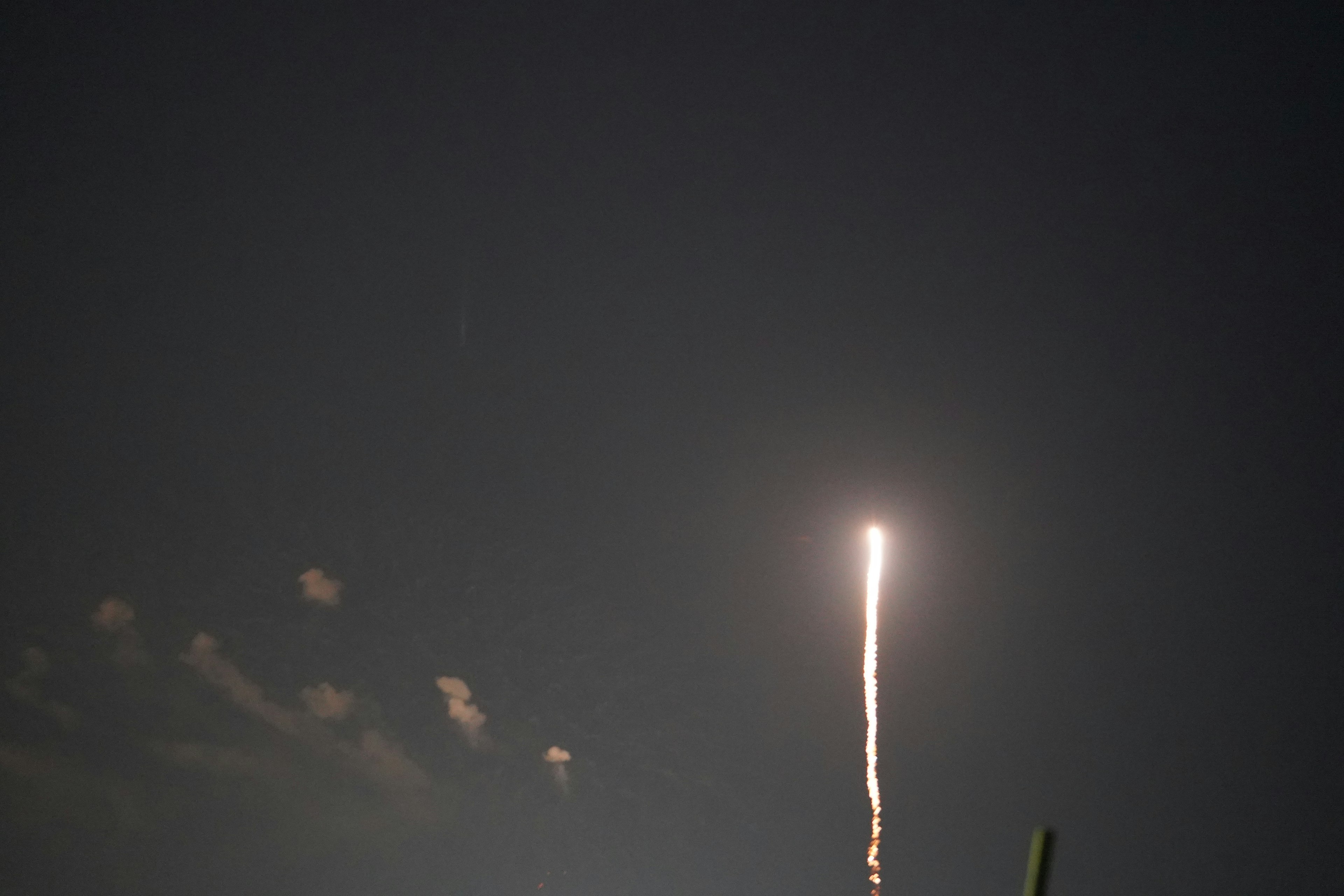 Bright trail of fireworks shooting into the night sky