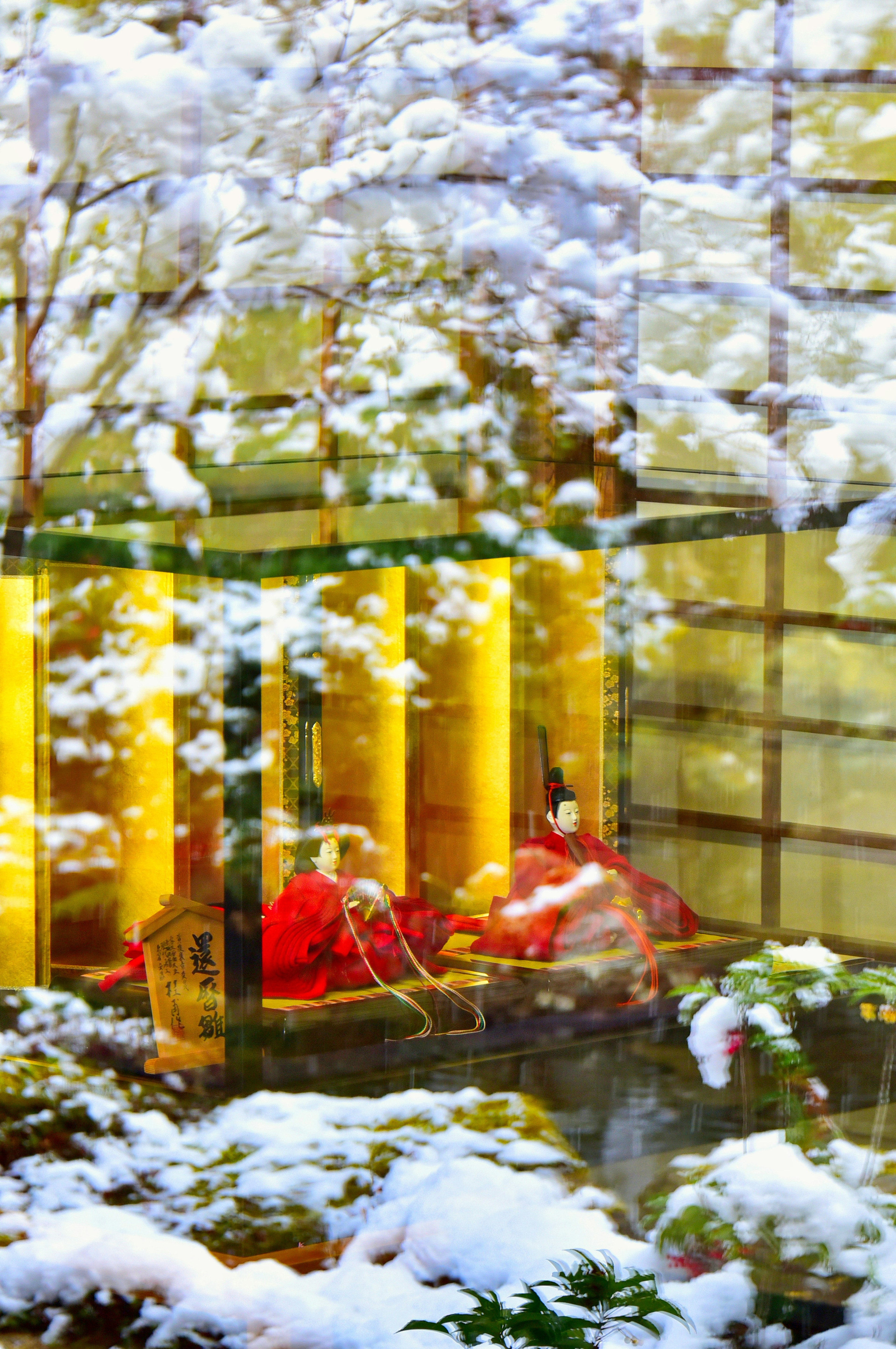 Warm interior view through a snow-covered window