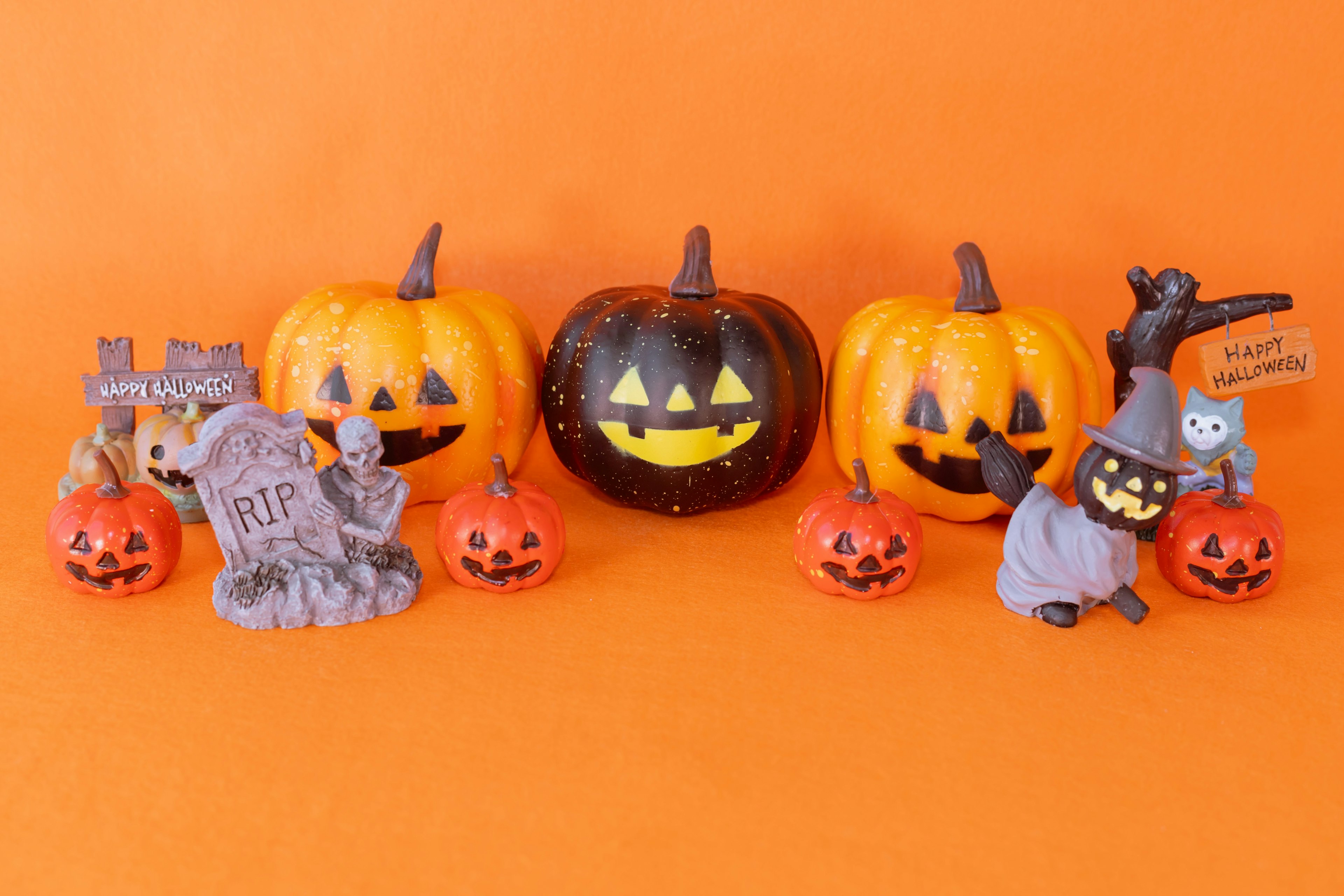 Colorful Halloween decorations featuring pumpkins and small figures arranged