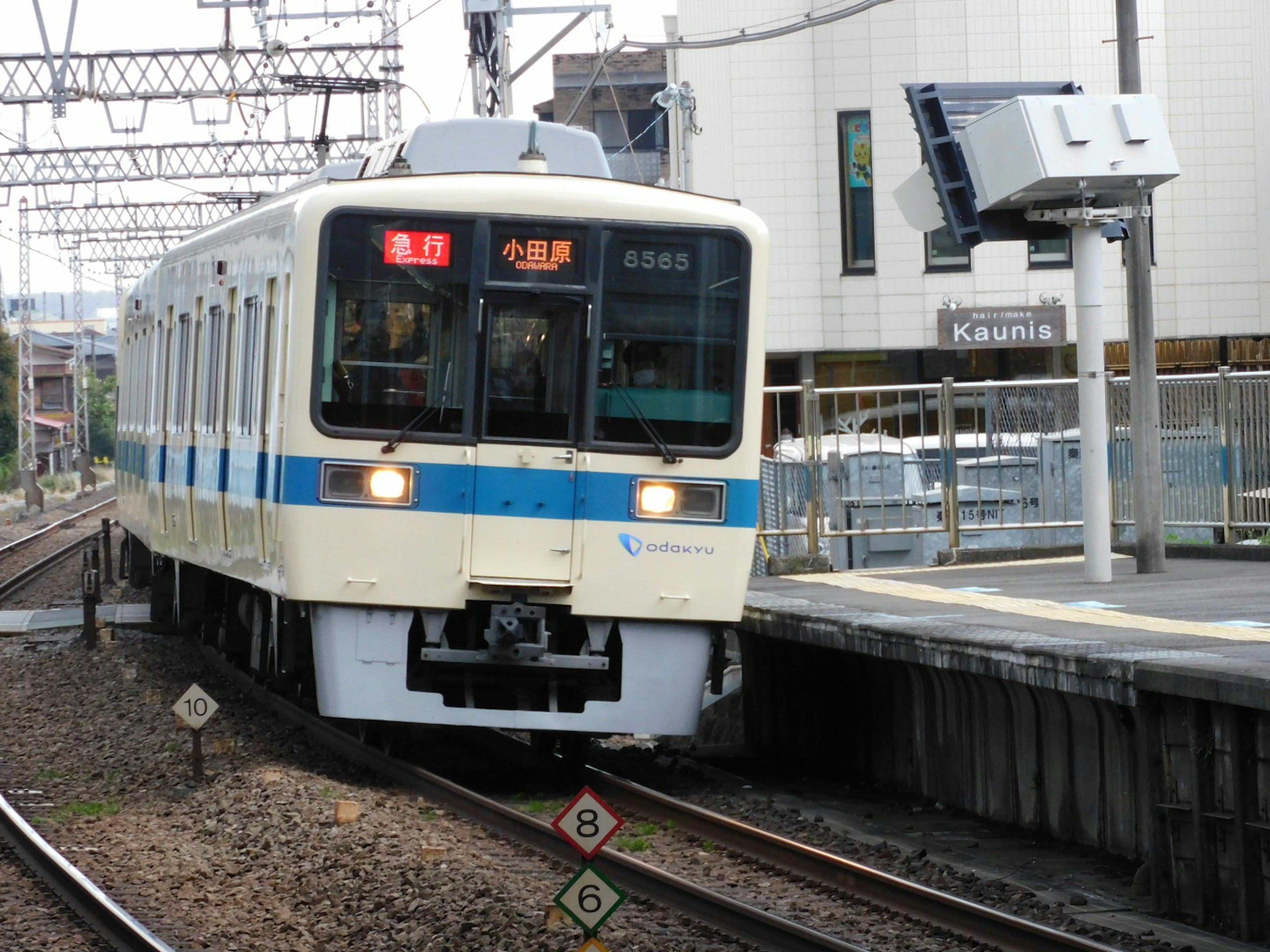 Train with blue stripes arriving at the station