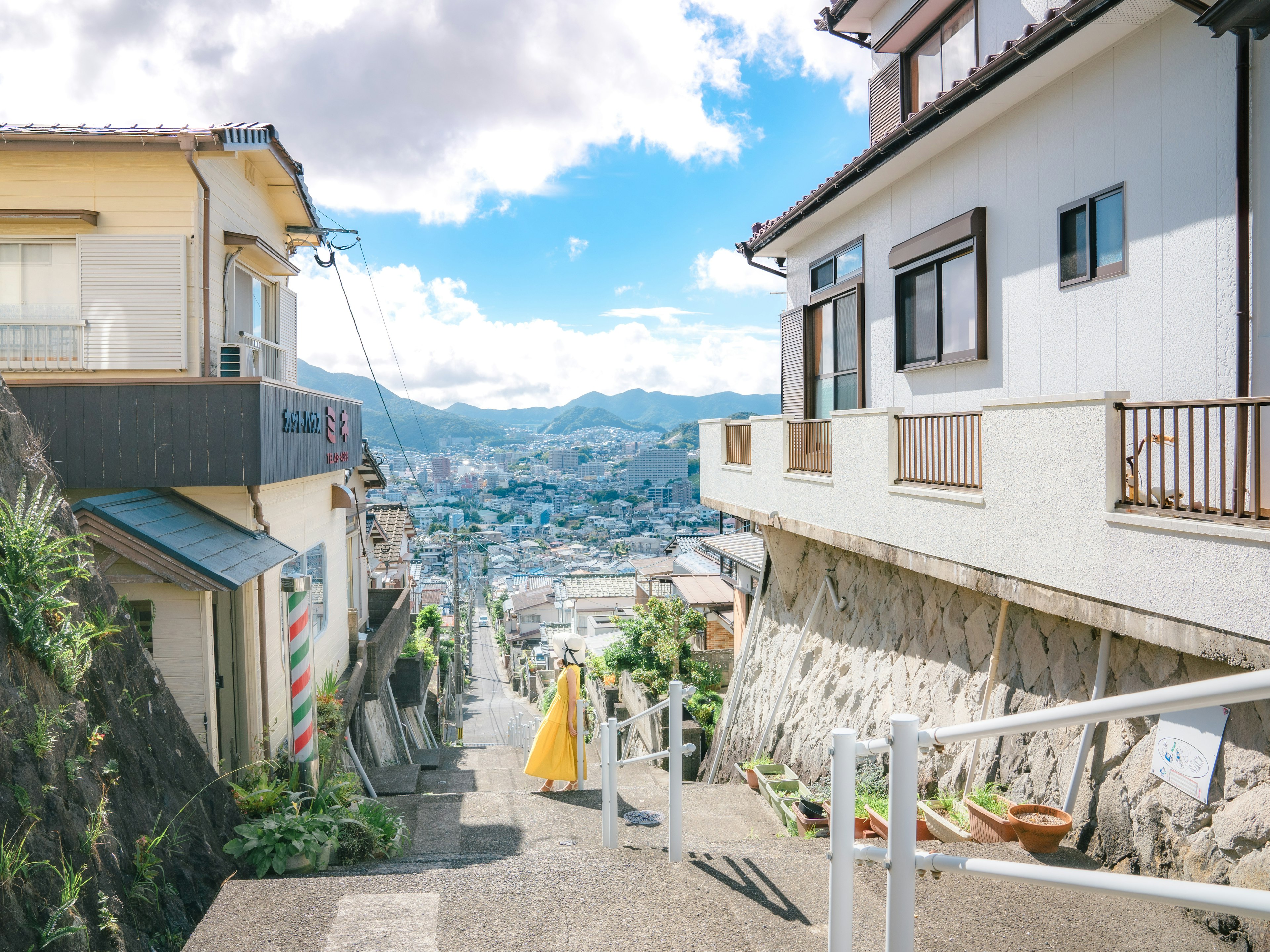 Residential street view with blue sky and mountains in the background