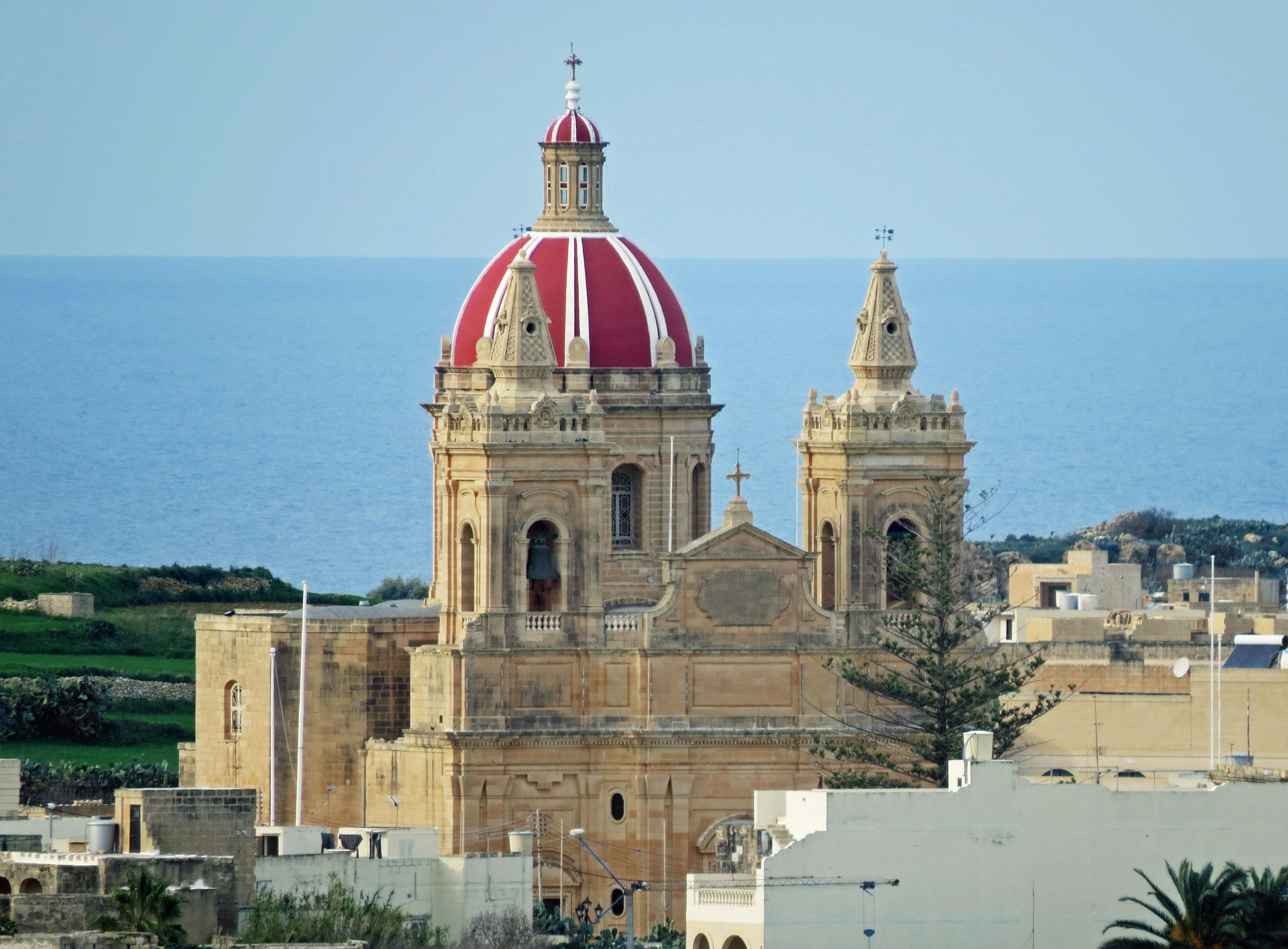 Church with a red dome and ocean background