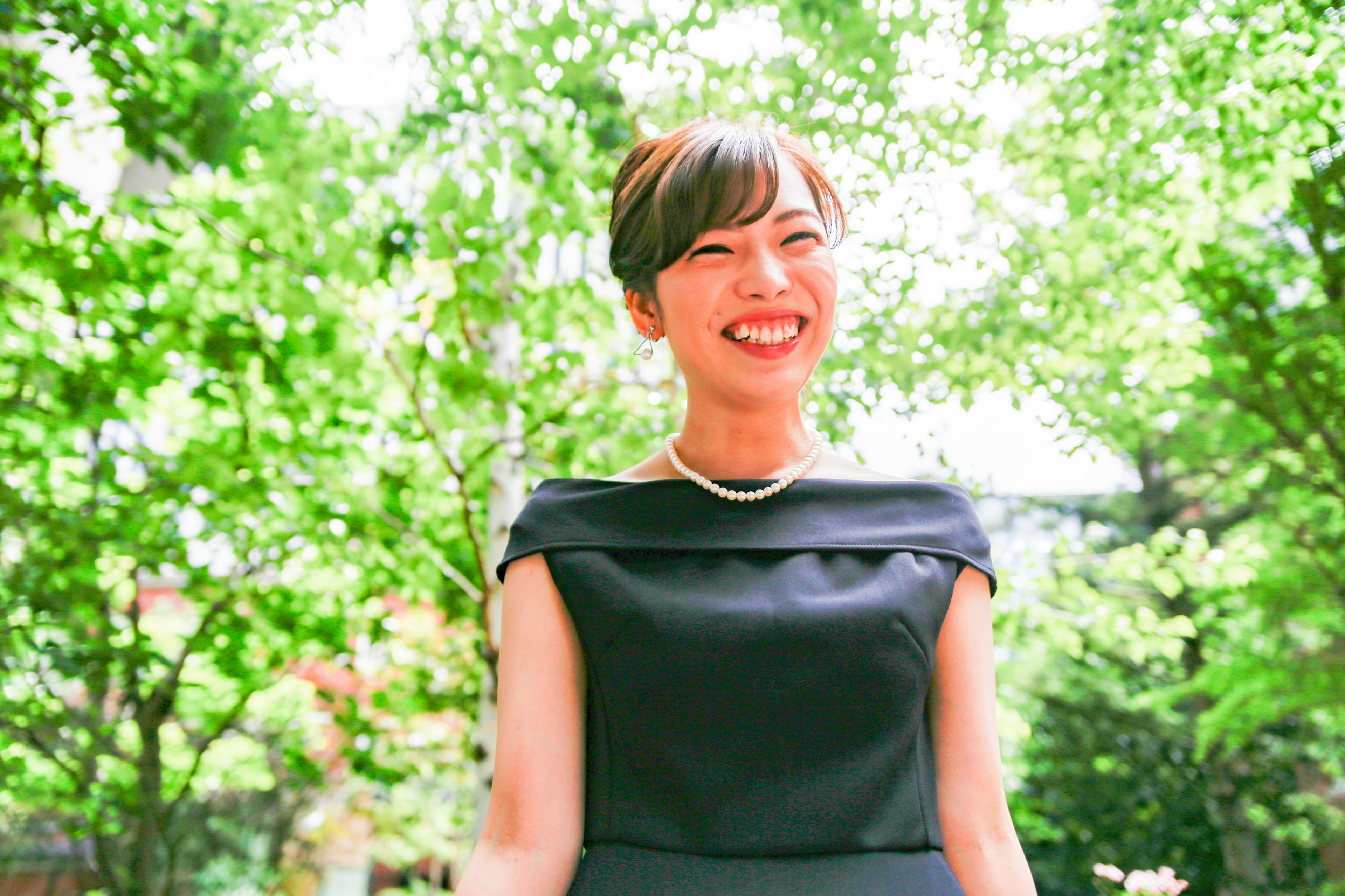 Portrait of a smiling woman in front of a green background