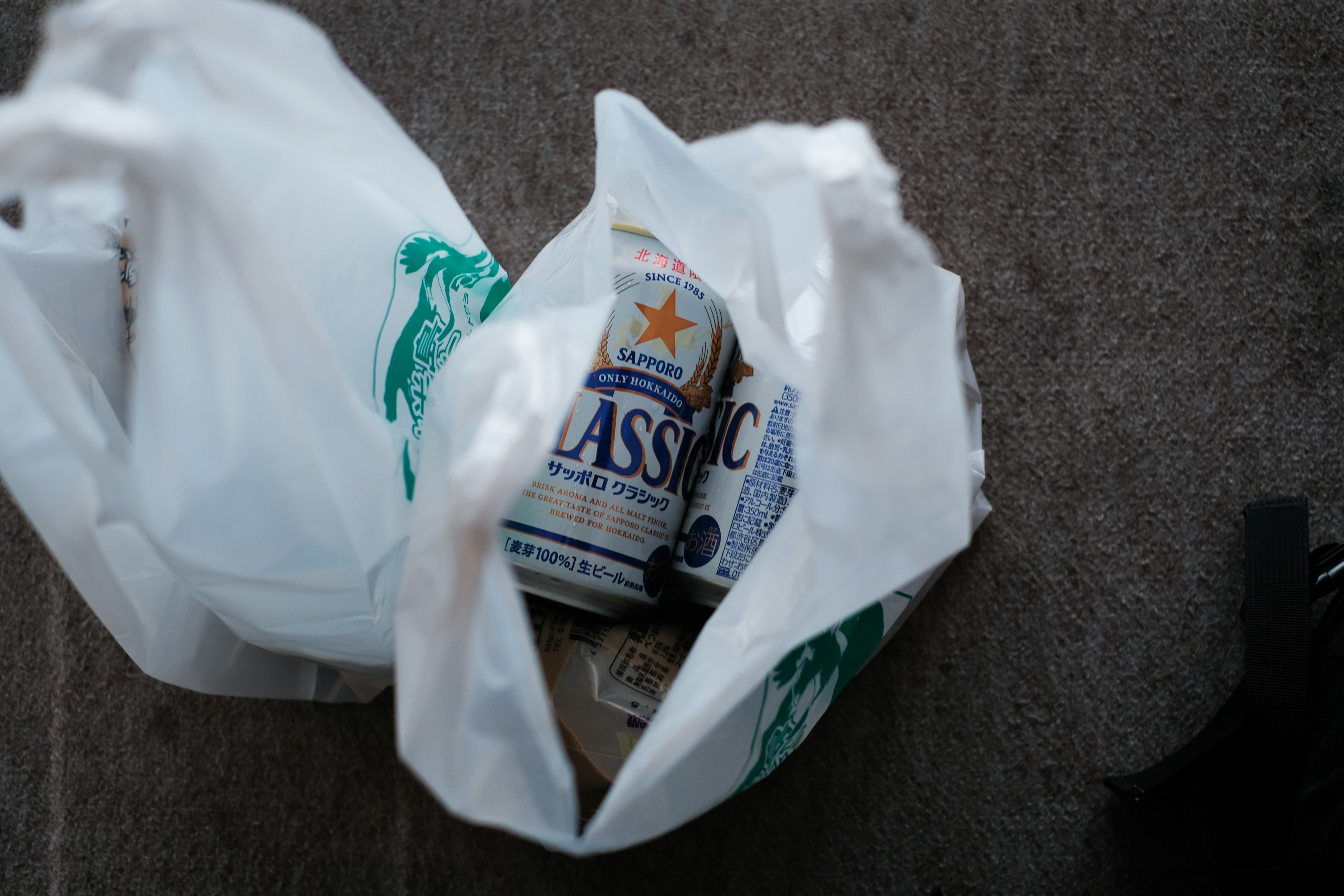 White plastic bag with cans inside