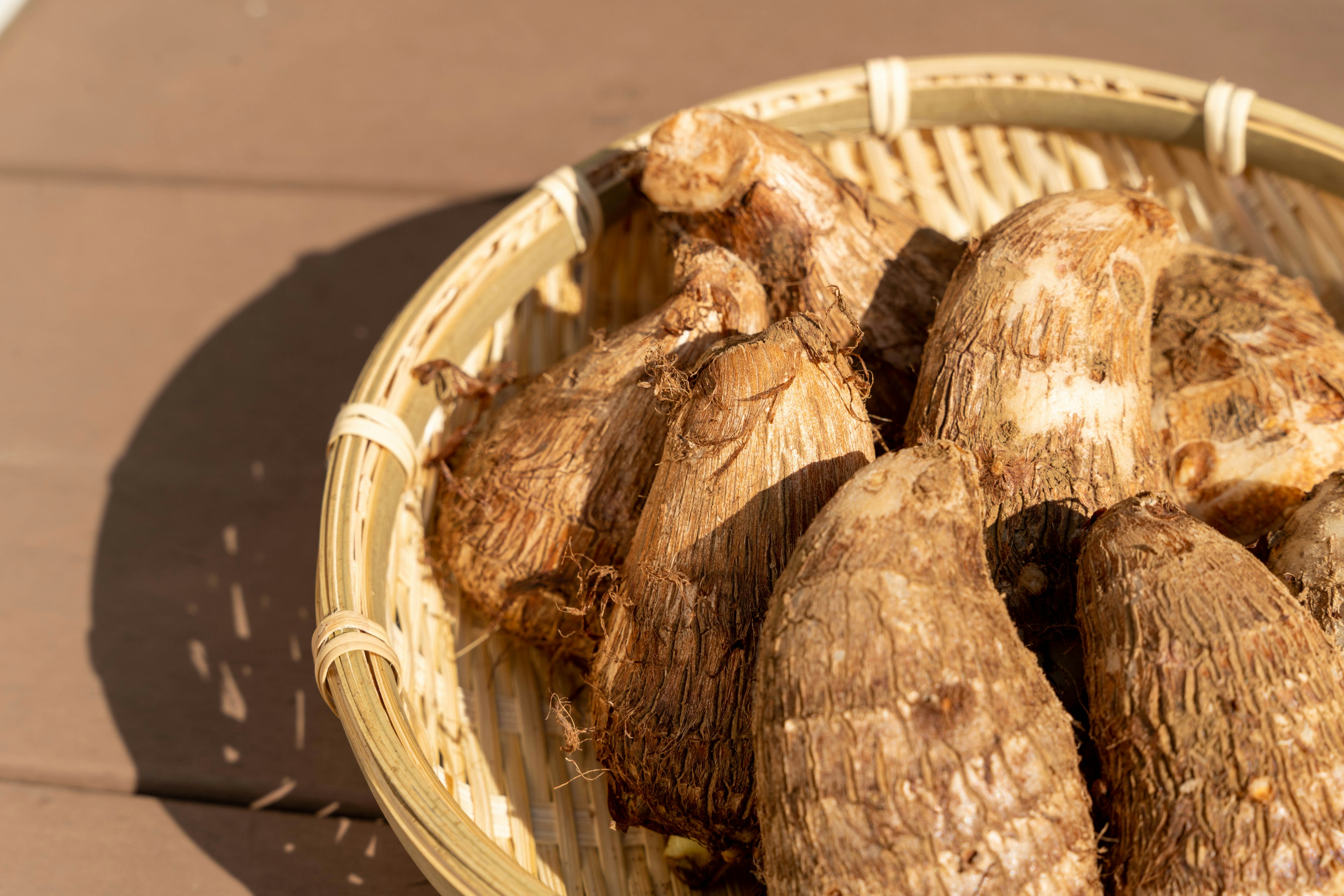 A basket containing several taro roots