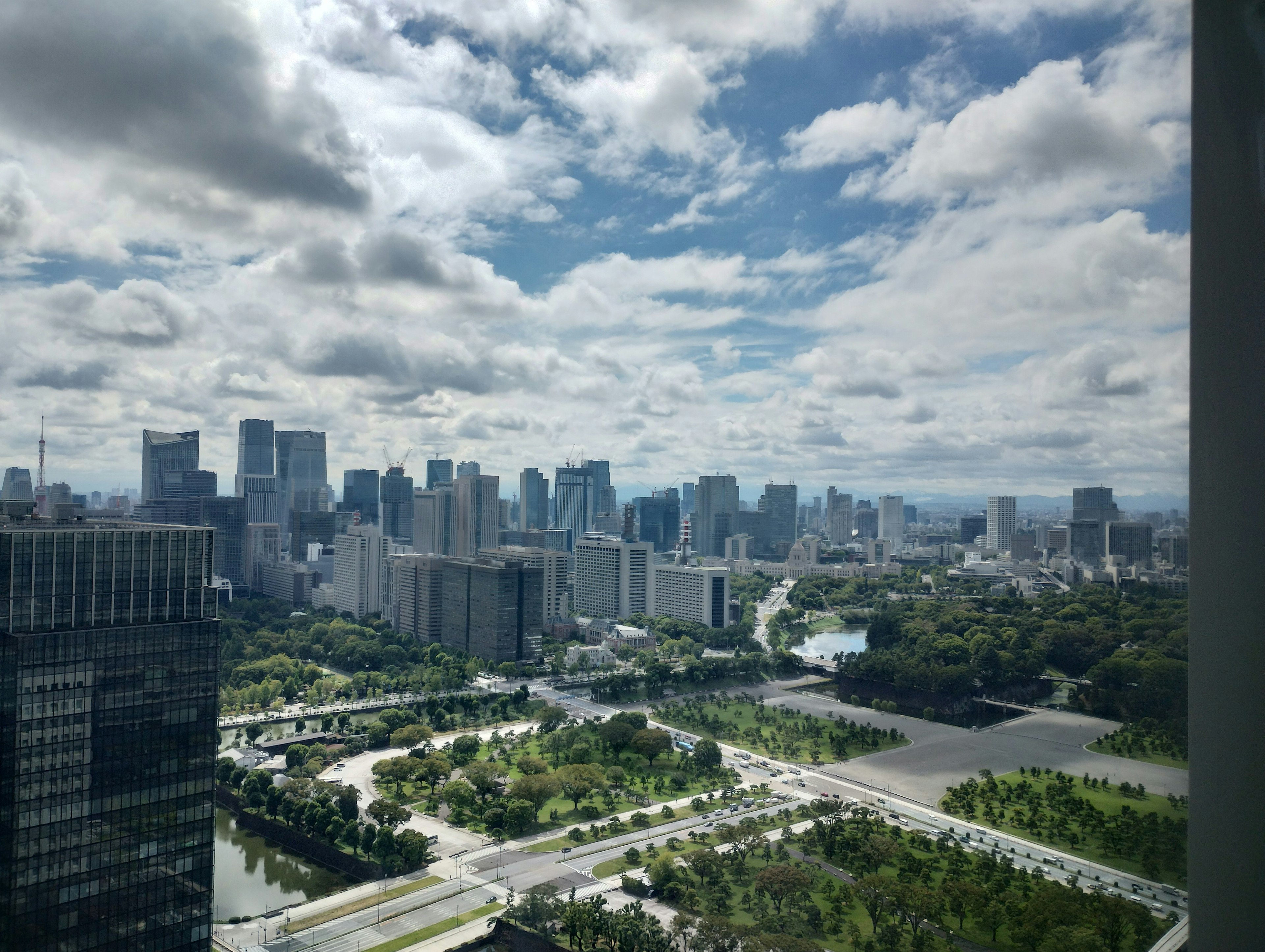 City skyline with tall buildings and lush green parks