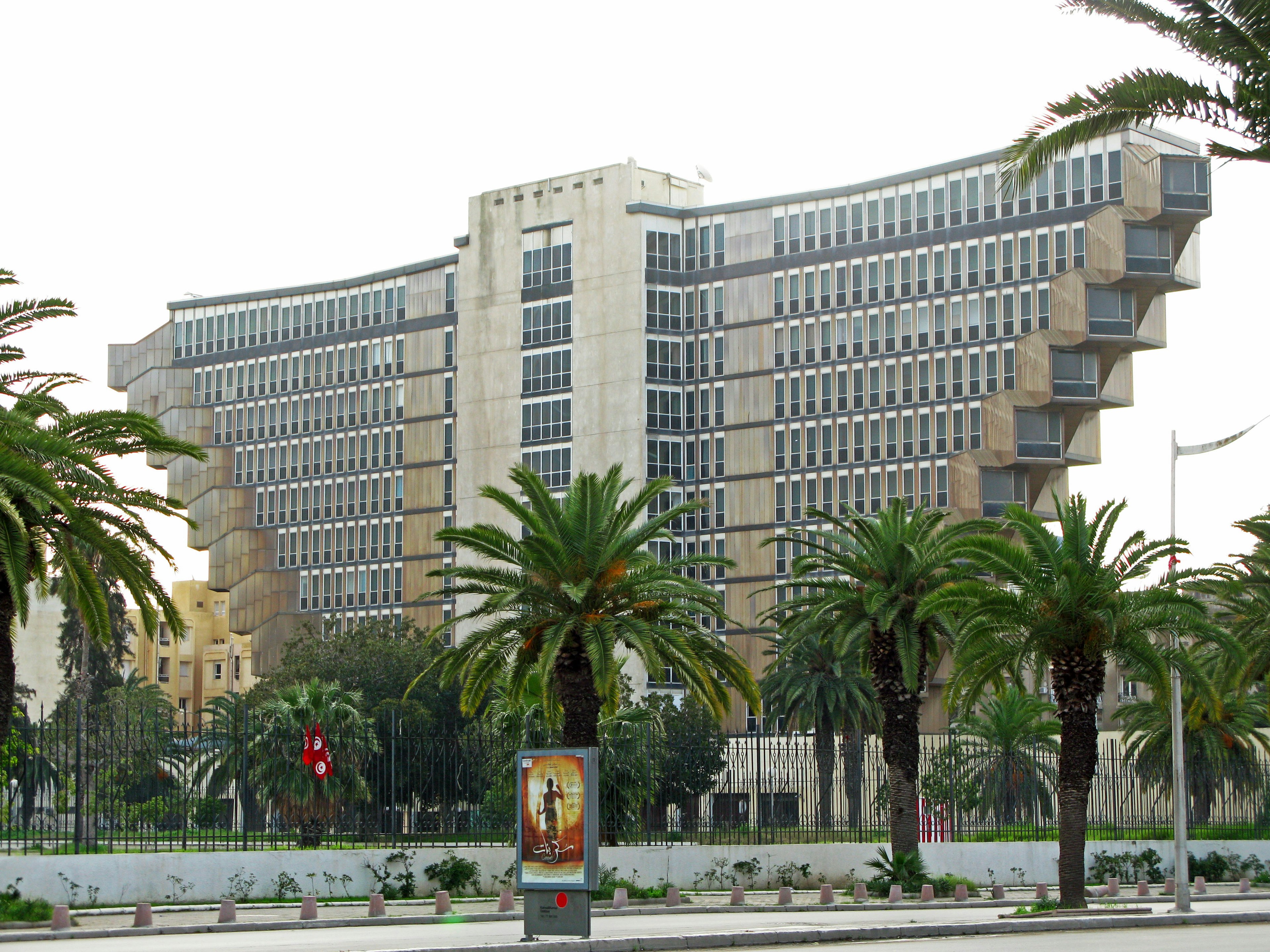 Unique architectural building design with surrounding palm trees