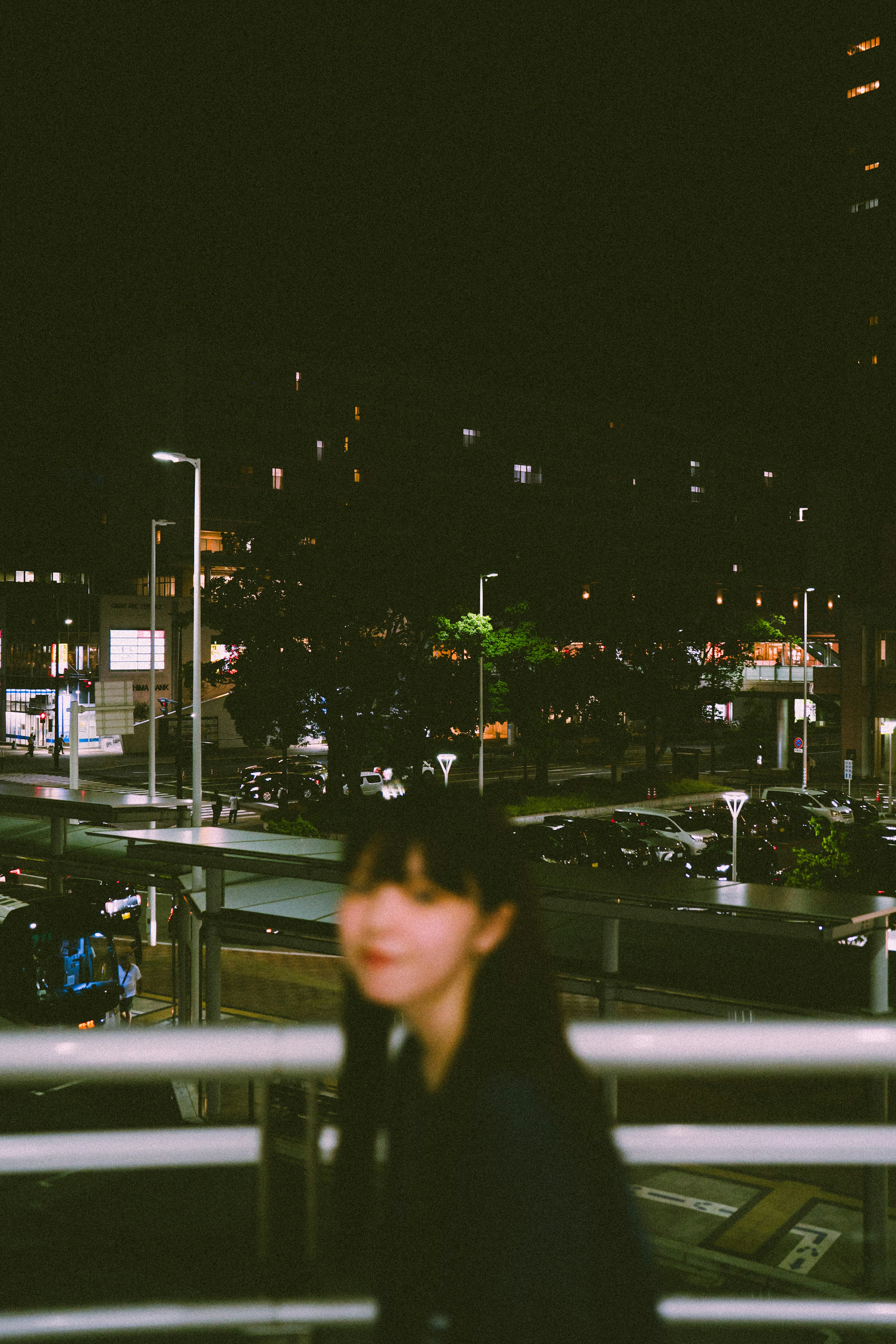 Blurred image of a woman with a night cityscape background