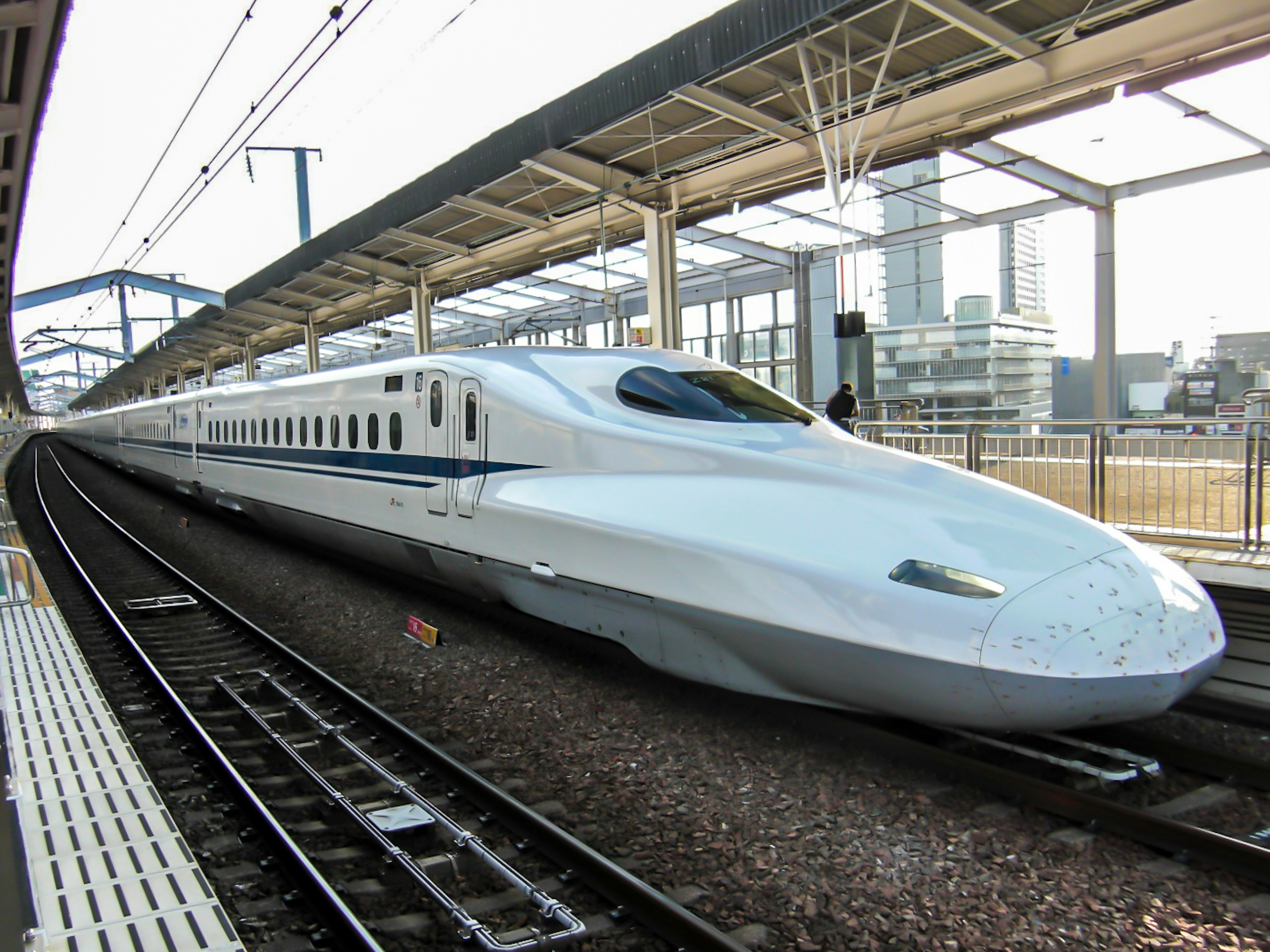 Shinkansen train at a station showcasing sleek white design