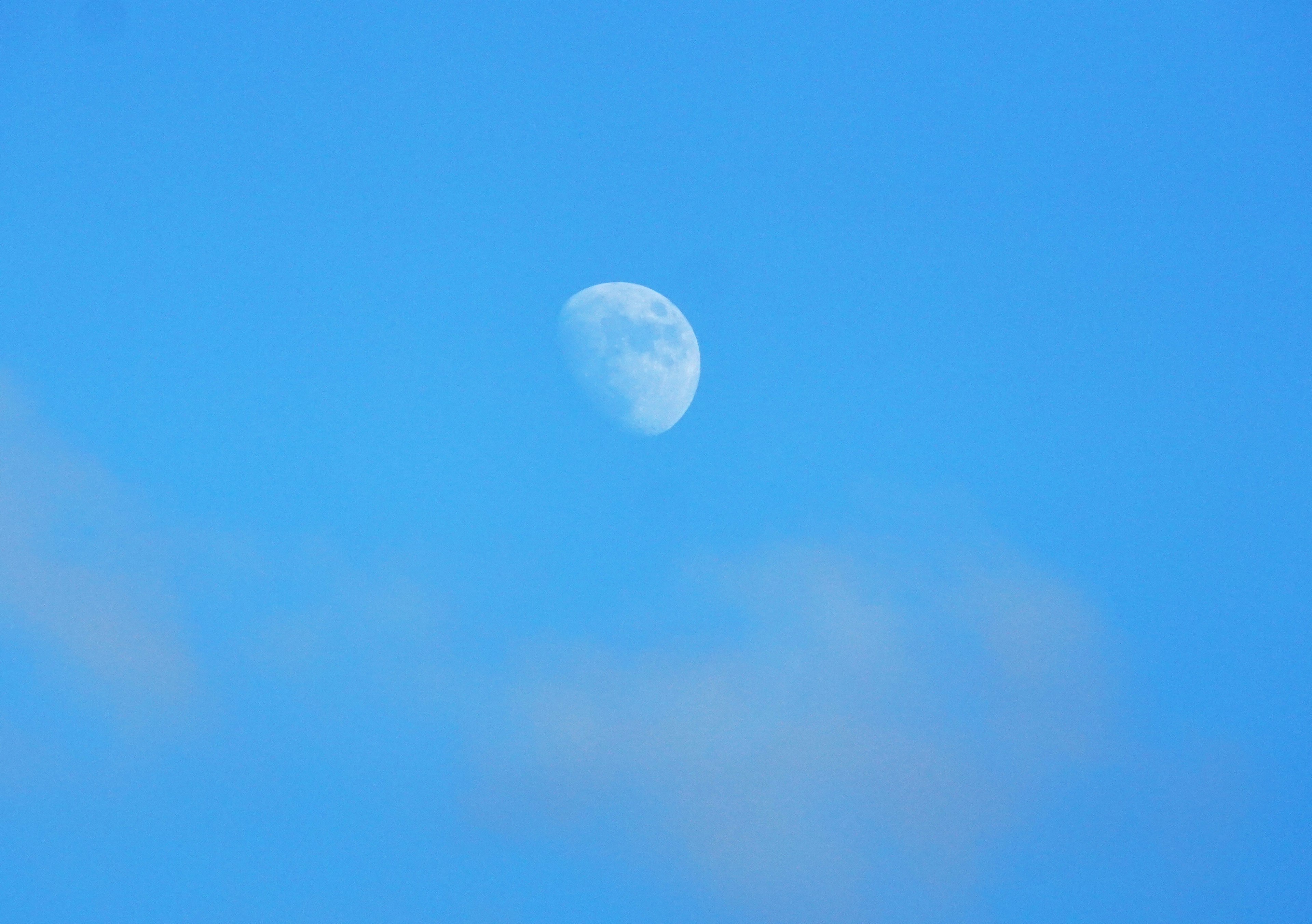 Acercamiento de la luna en un cielo azul claro