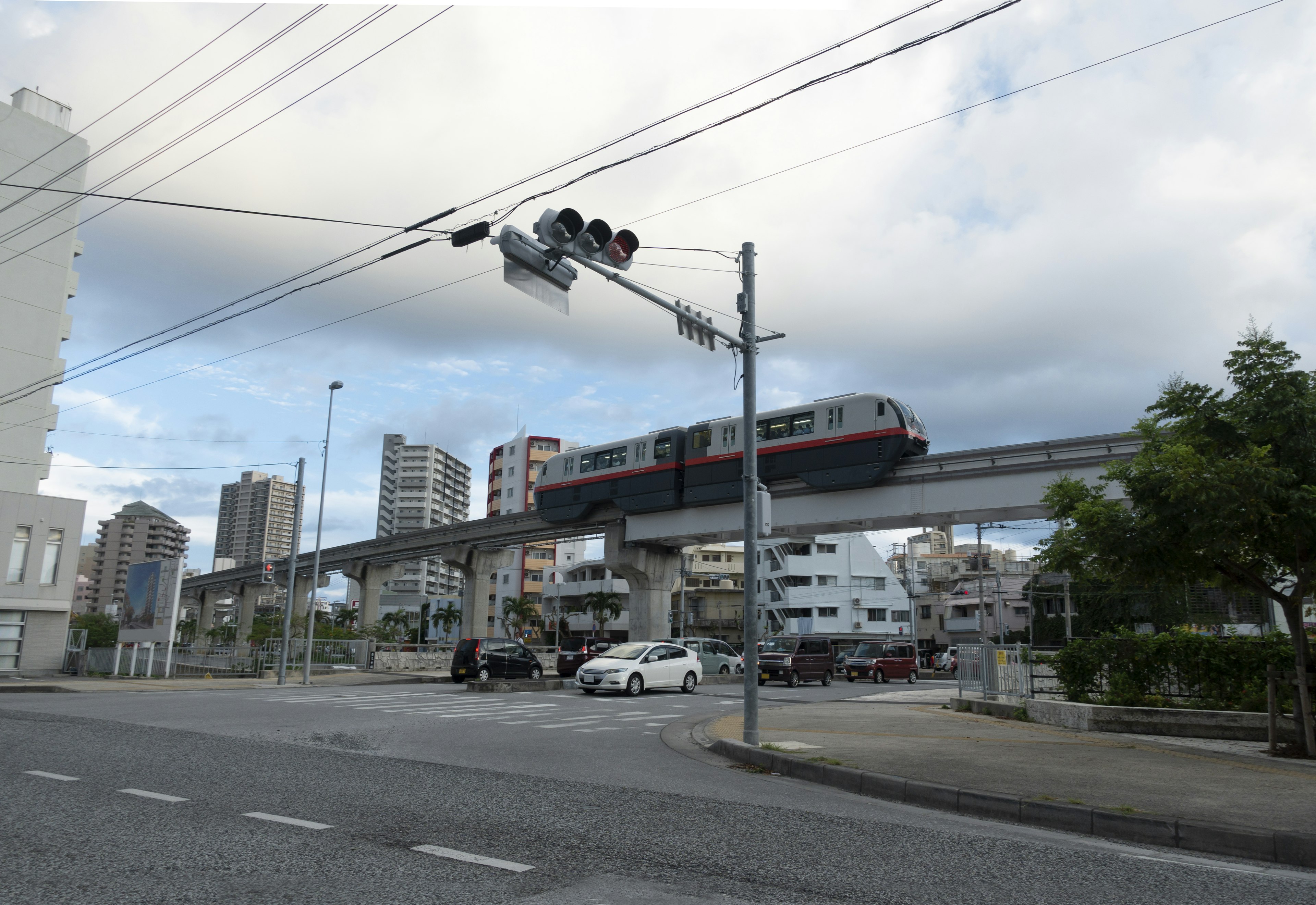 Monorail running on an elevated track in an urban landscape with a blue sky