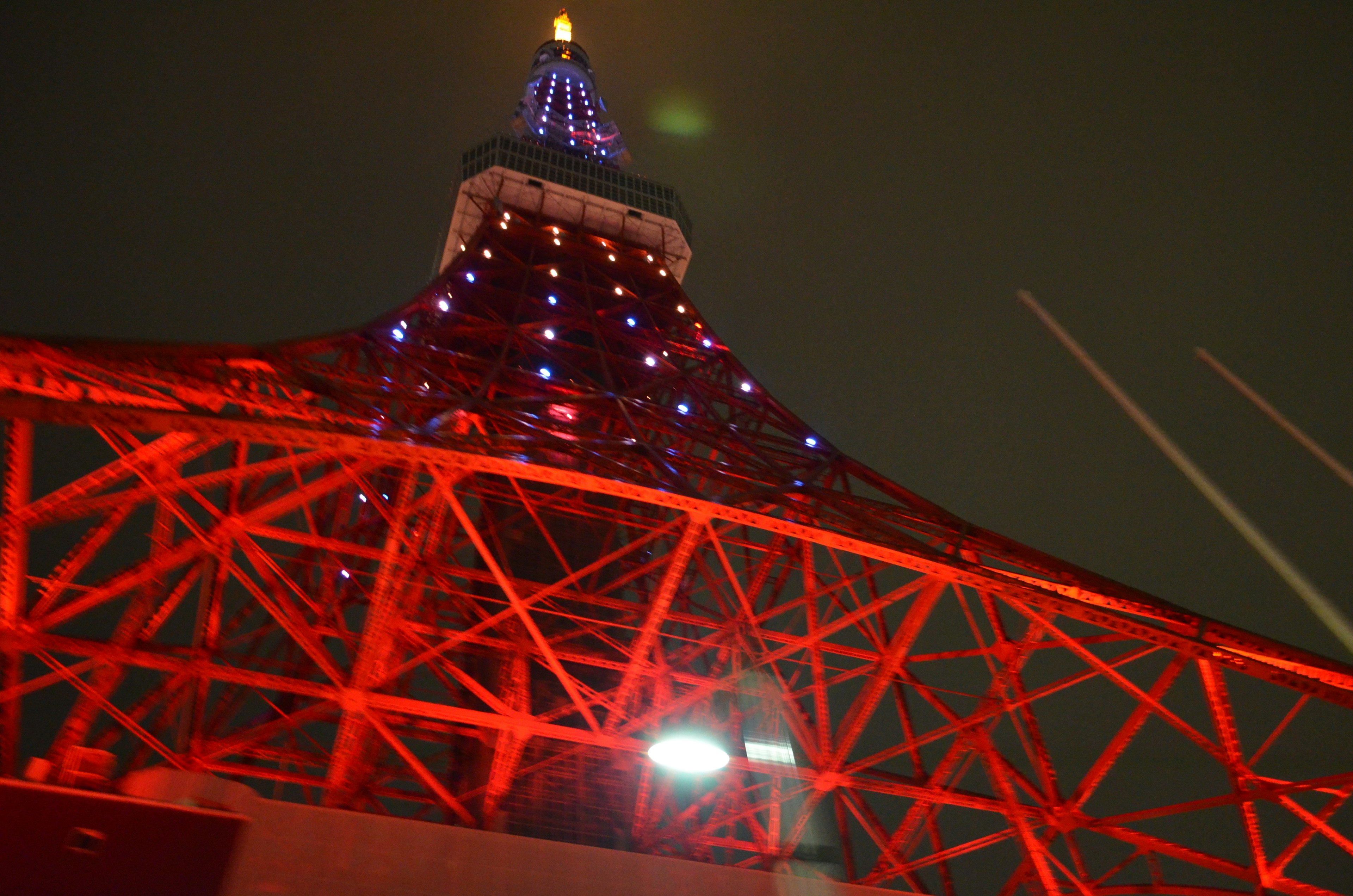 Tokyo Tower with striking red structure and blue lighting at night