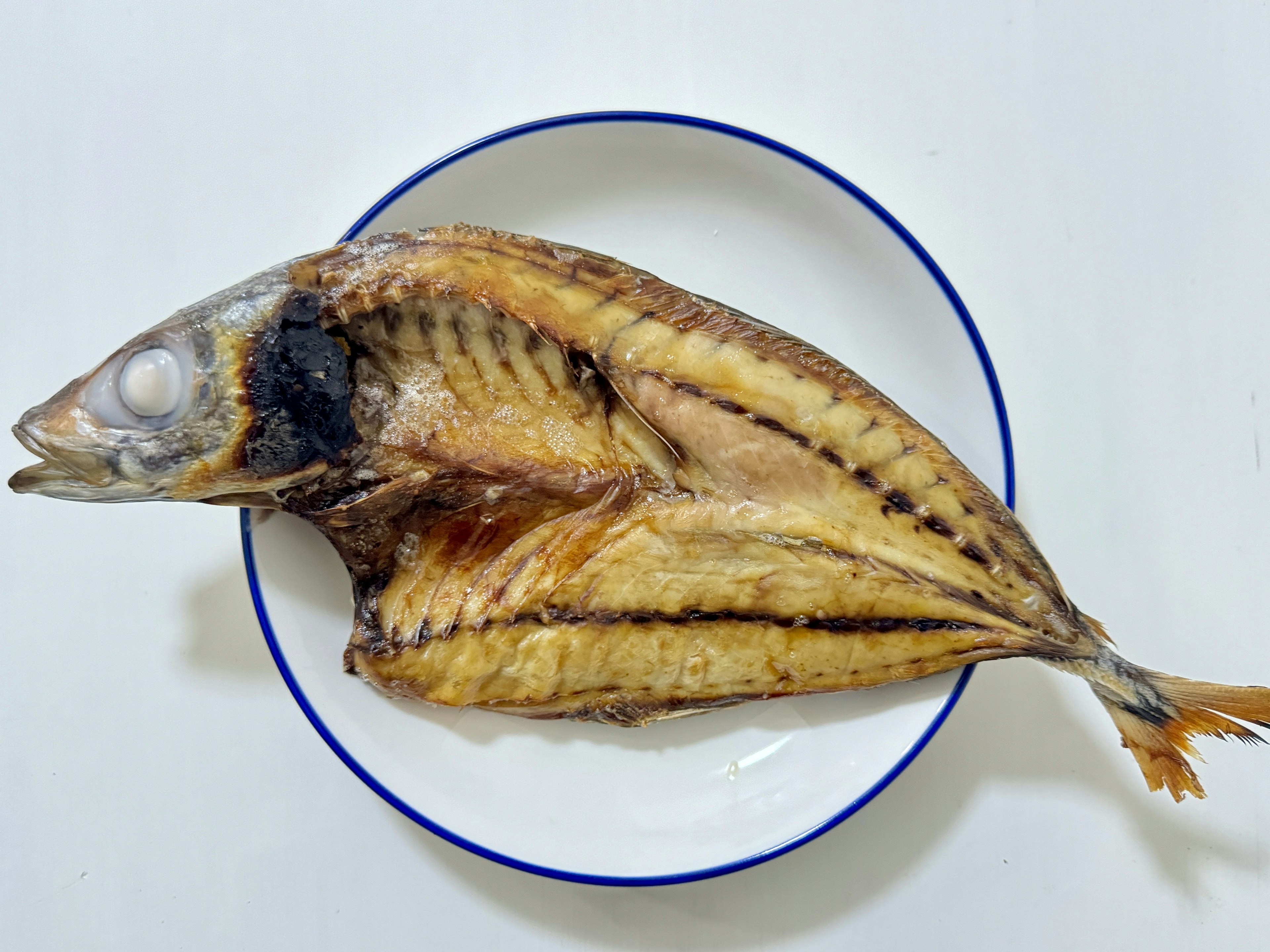 Dried fish placed on a white plate