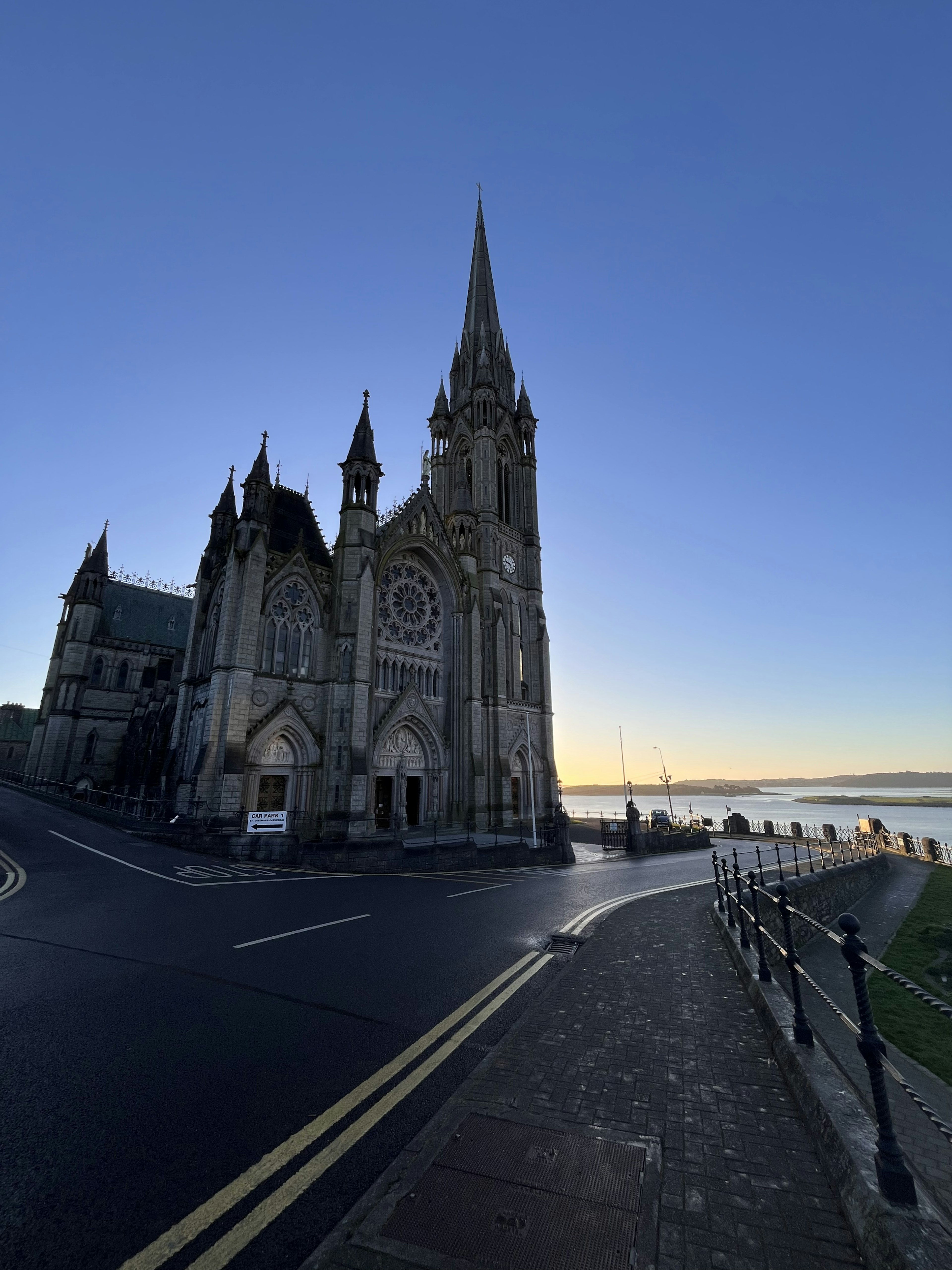 A beautiful church building standing at a street corner during sunset