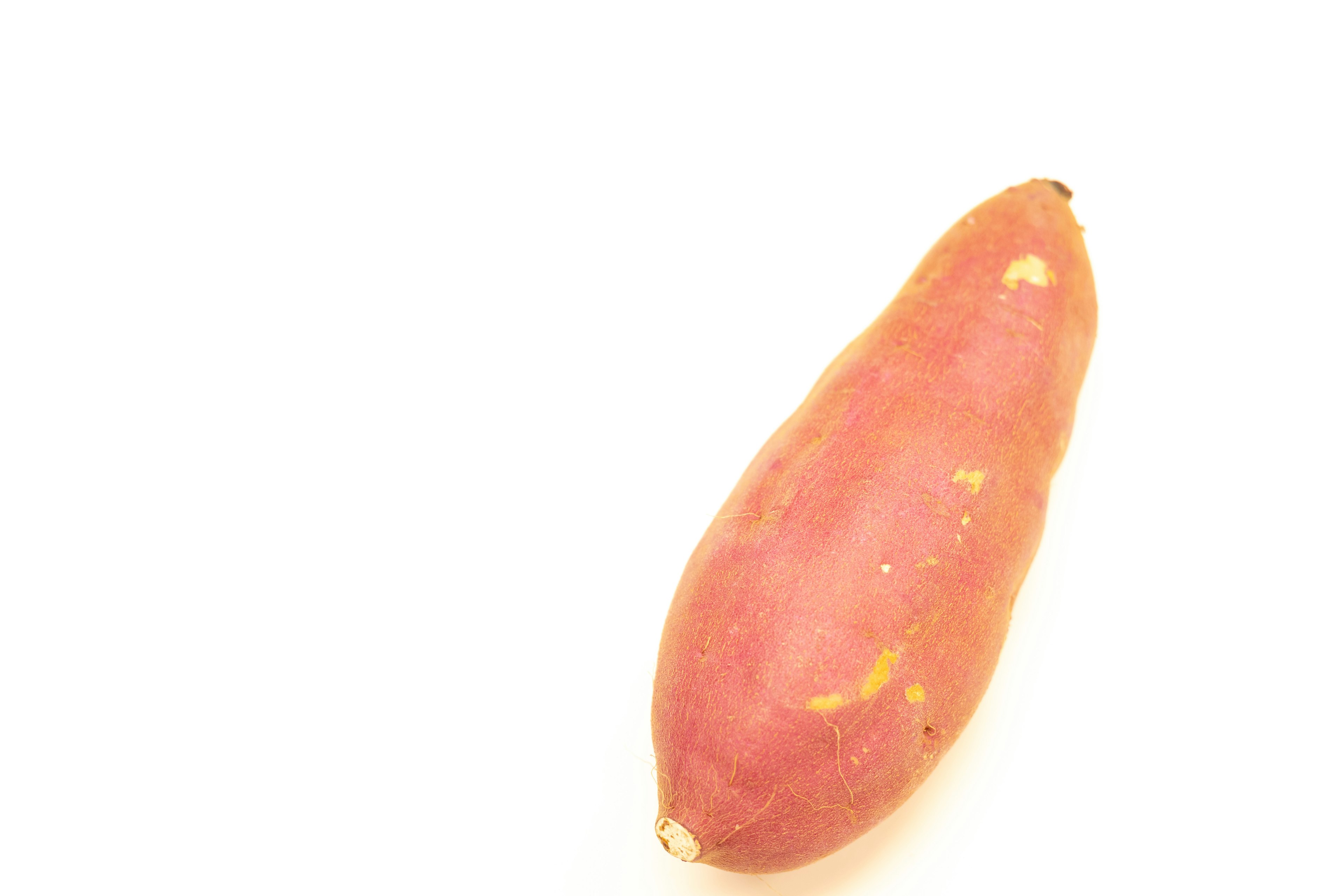 A purple sweet potato on a white background