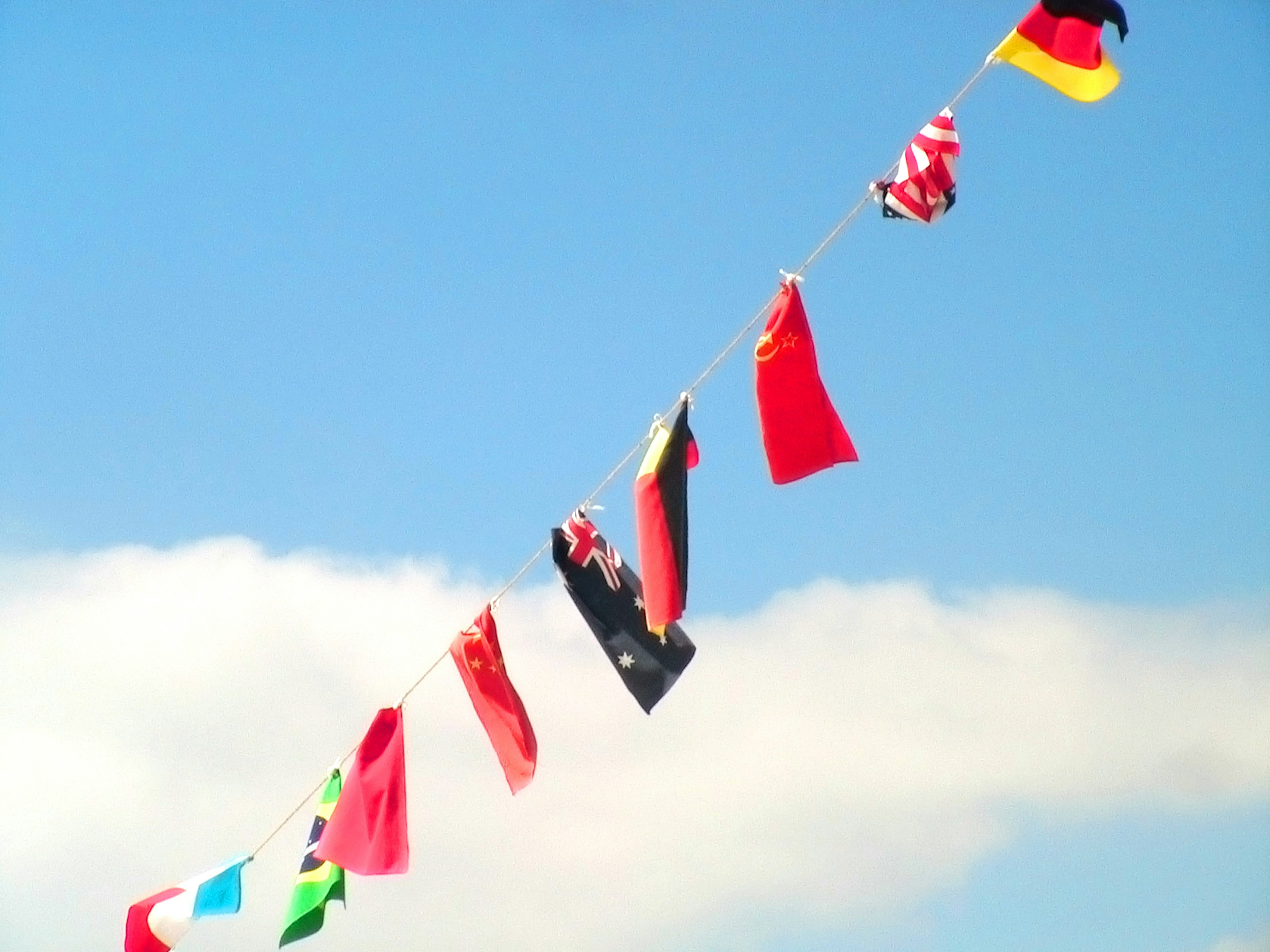 Bunting of international flags against a blue sky