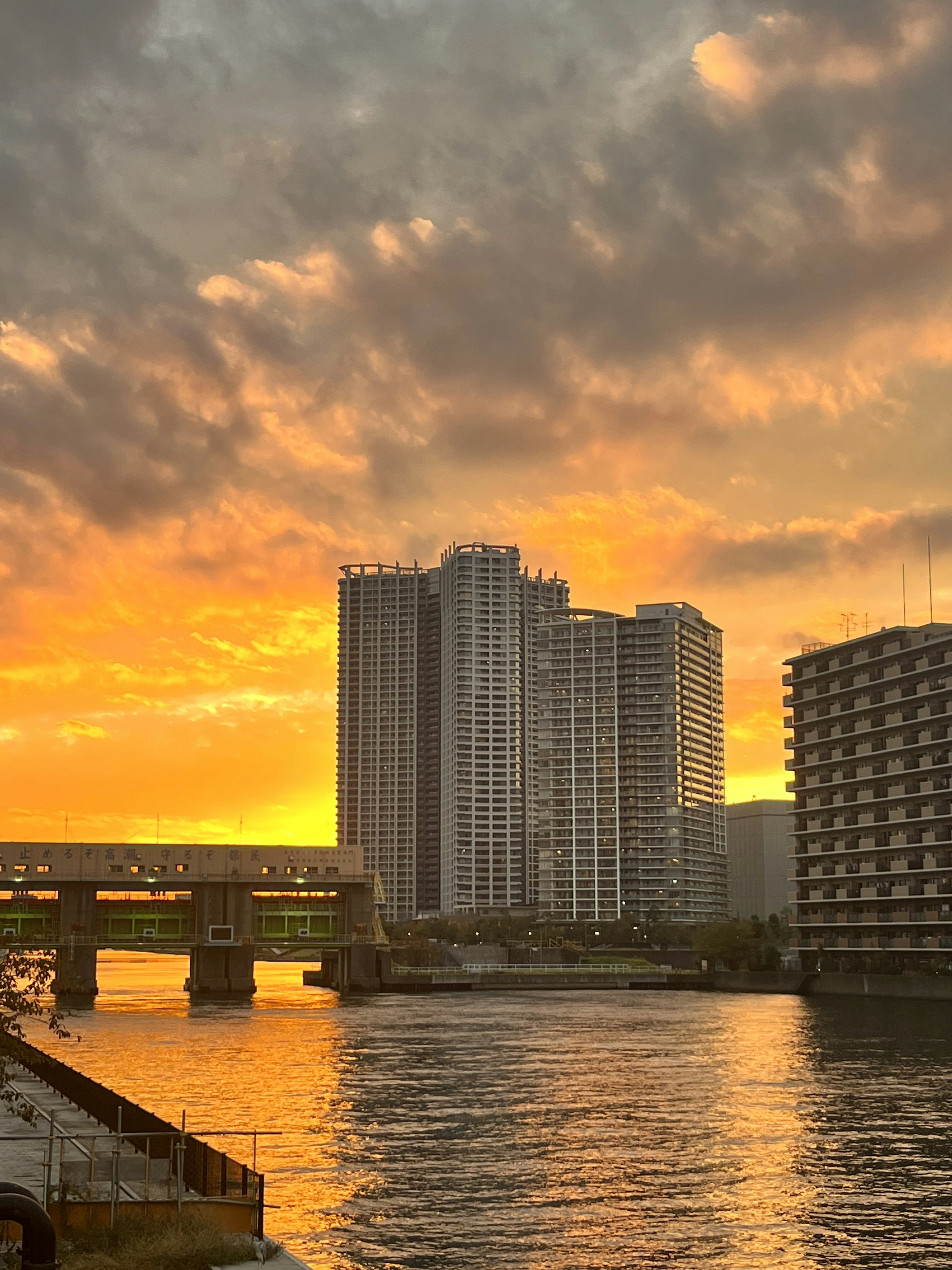 Skyline di grattacieli contro un cielo al tramonto sopra un fiume